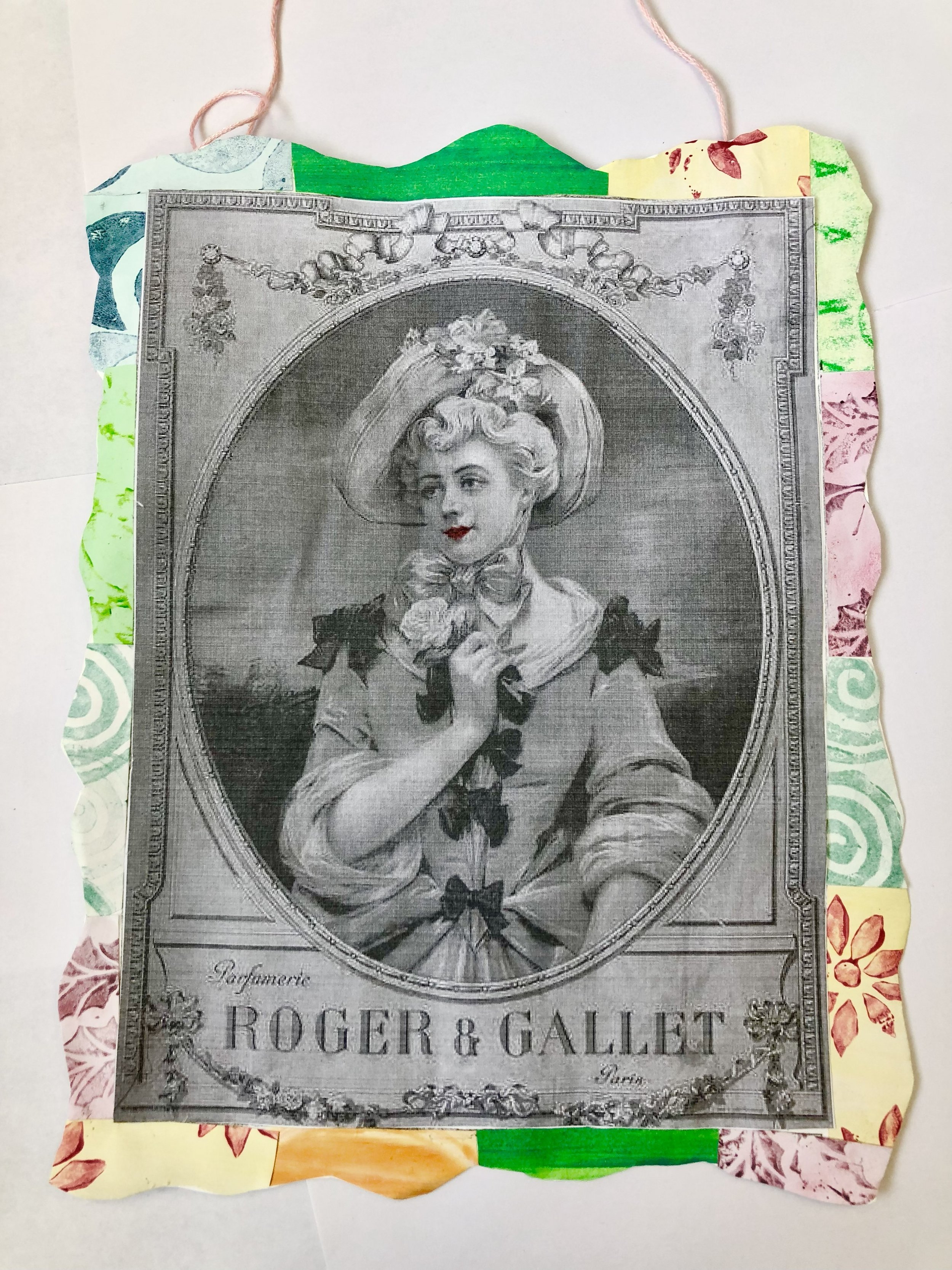 A black and white vintage-style illustration of a woman wearing a large hat with flowers, holding a flower near her face. The illustration is bordered by a colorful, patterned paper frame with floral designs and swirls.