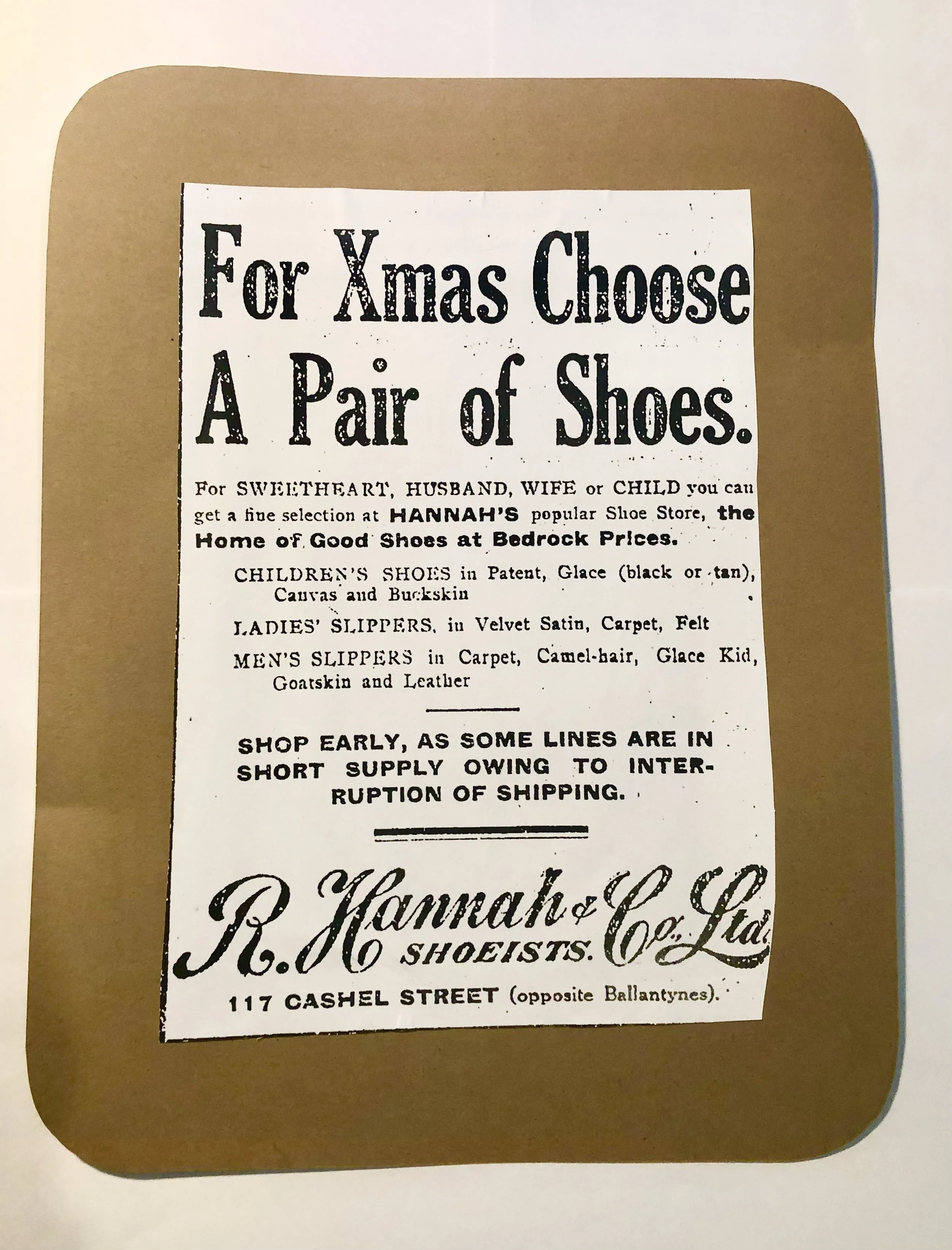 Old-fashioned Christmas shoe store advertisement offering shoes for women, children, men, and family members, including slippers and specialized designs, located at 117 Cashel Street.