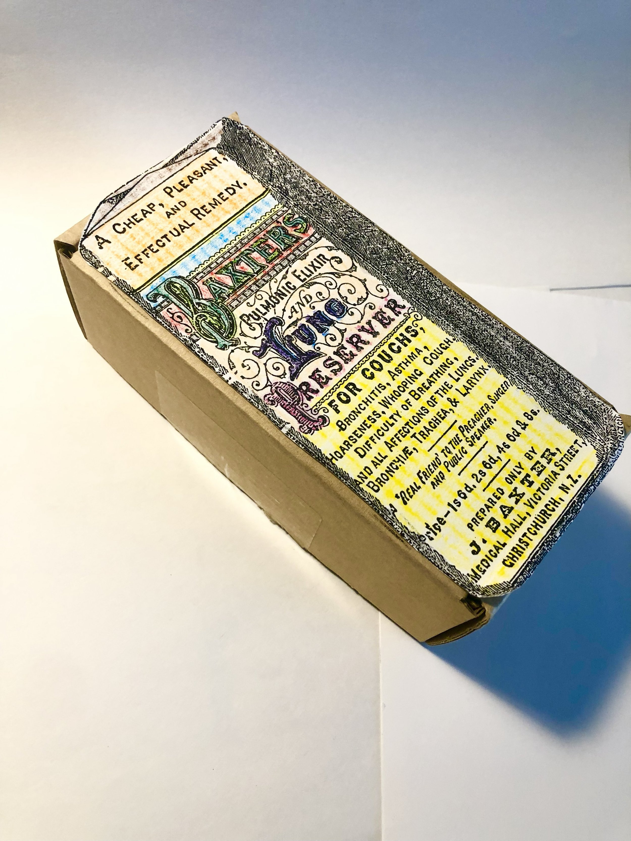 A vintage-style medicine box with ornate lettering describing a cough remedy with ingredients and instructions.
