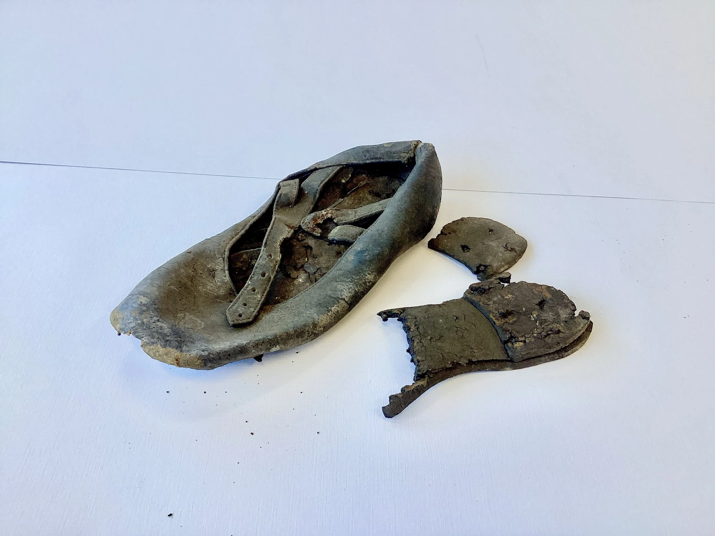 Old, rusted bicycle saddle with broken and rusted parts, isolated on white surface.