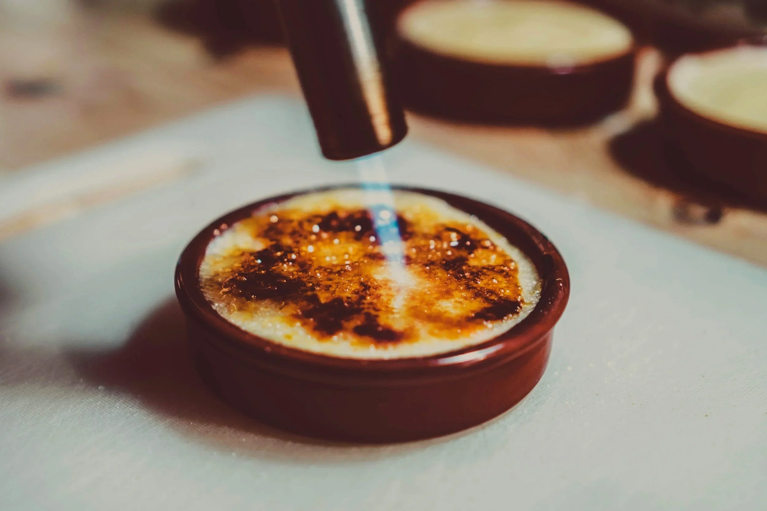 Torching the top of a Crème Brulé