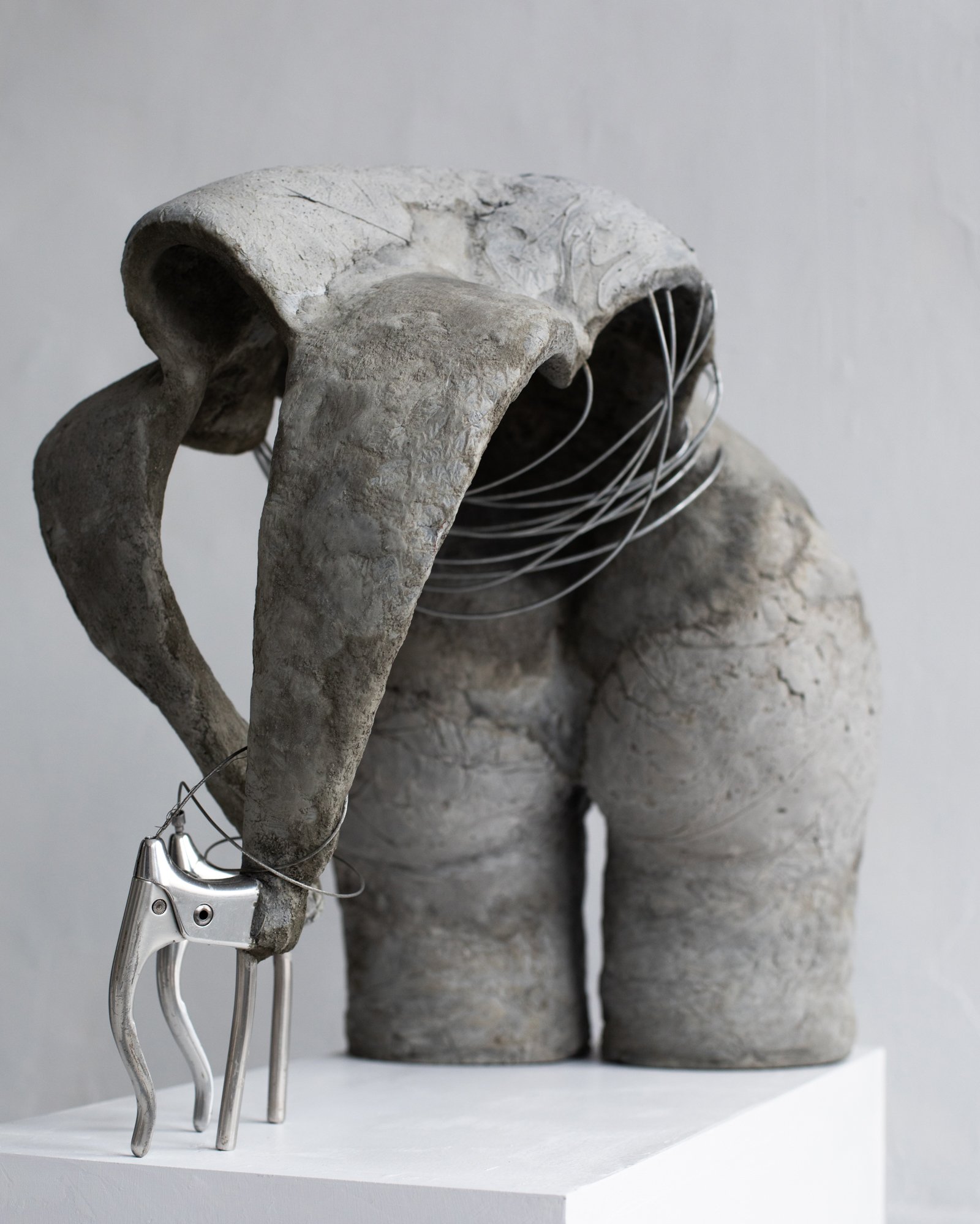 Riding Backward with No Breaks, 2025.  
Hand sculpted concrete, steel, vintage bicycle breaks and break wire.  
25 x 20 x 12 inches.