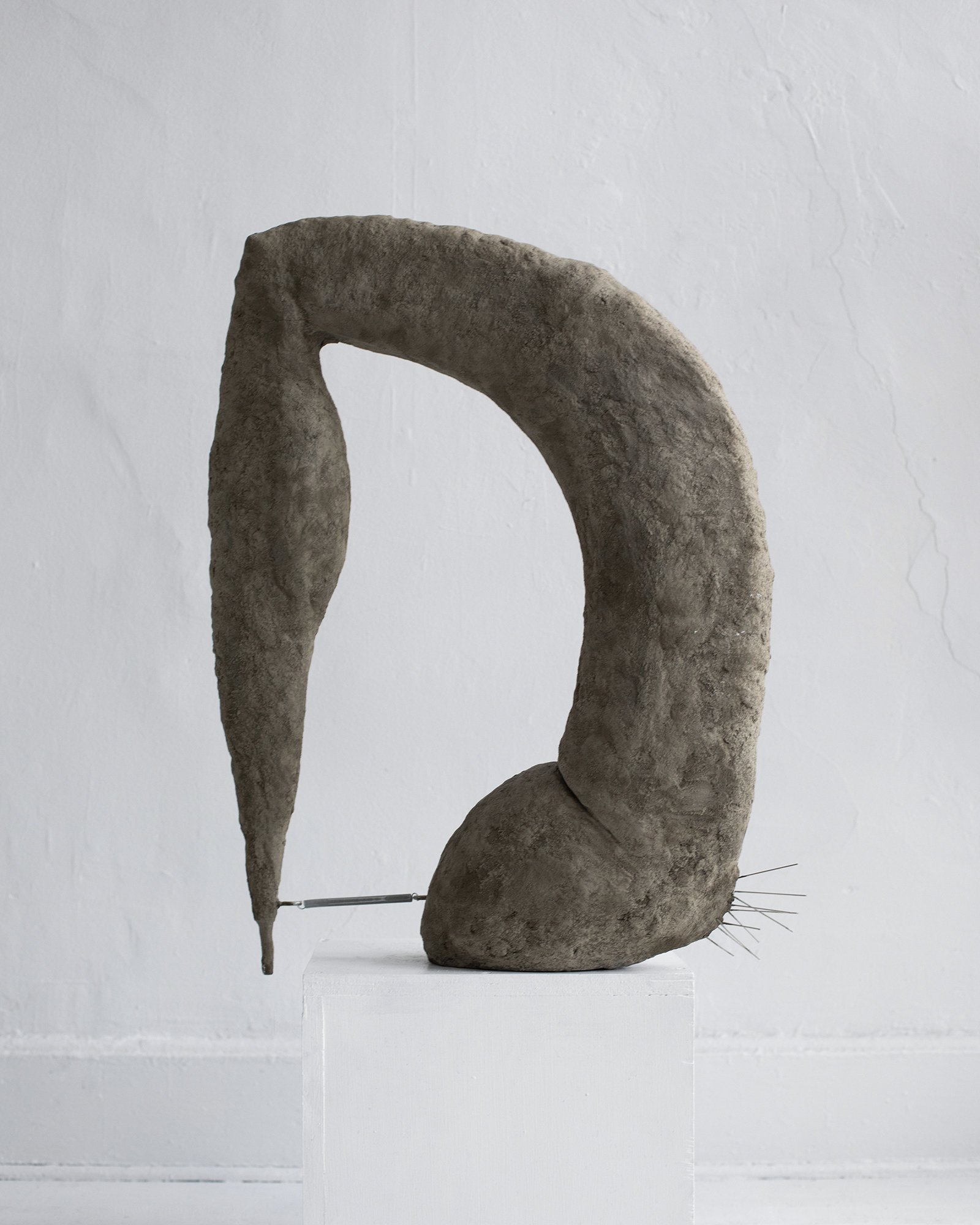 Leg Up, 2024. Hand sculpted concrete, steel bird spikes and steel spring. 27.5 x 21.5 x 6 inches.
