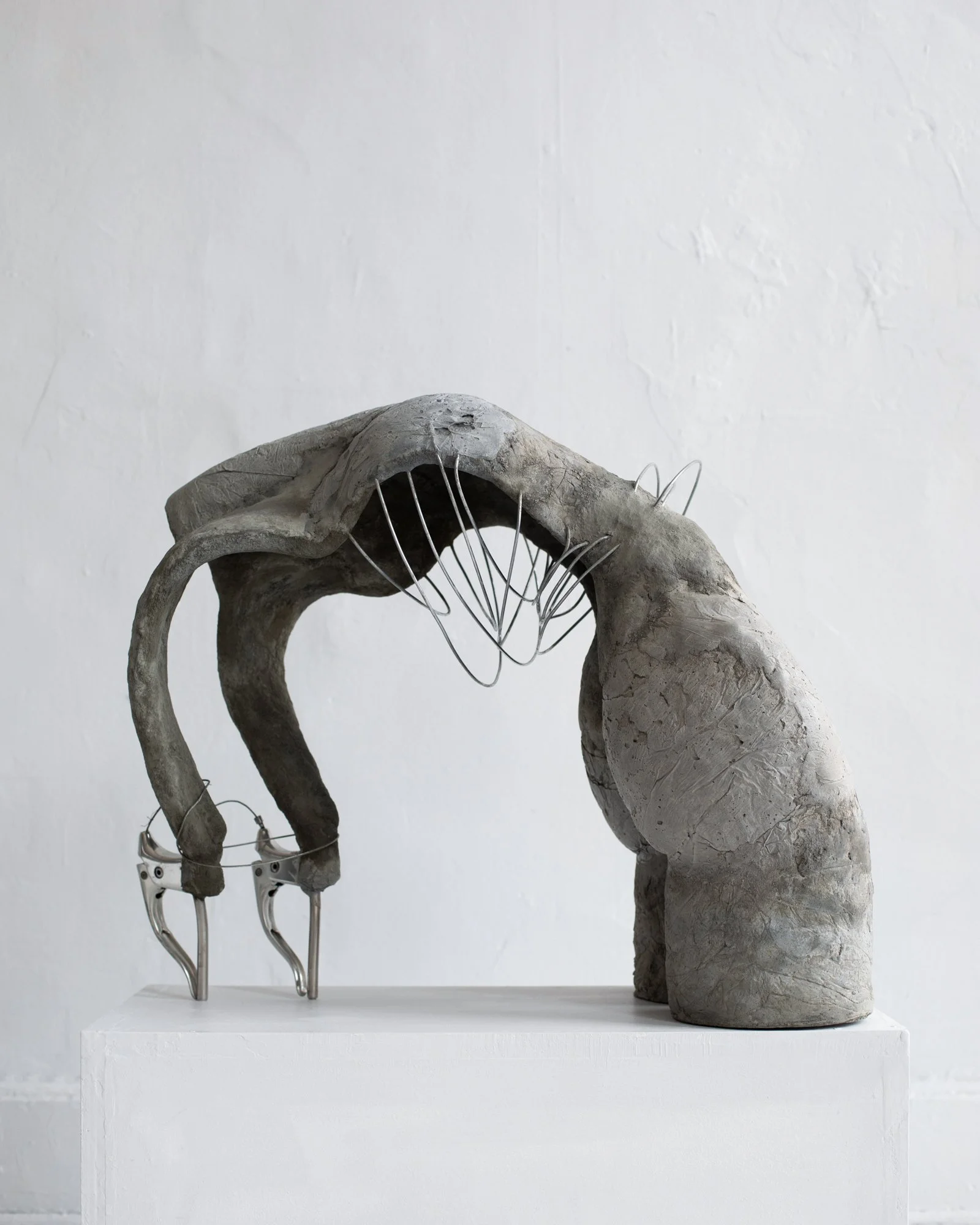 Riding Backward with No Breaks, 2025.  
Hand sculpted concrete, steel, vintage bicycle breaks and break wire.  
25 x 20 x 12 inches.