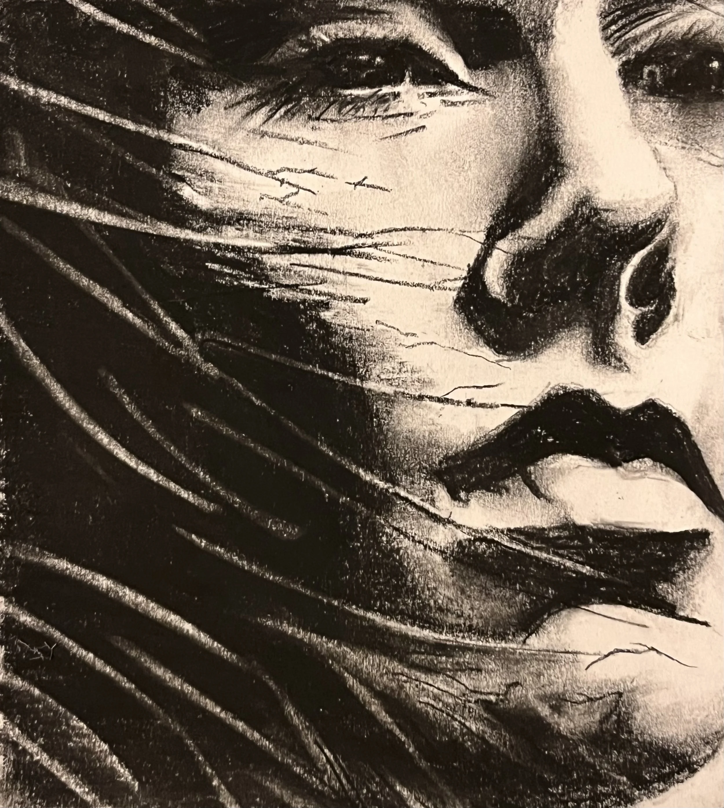 Black and white close-up of a woman's face with long hair, logo lips, and partially closed eyes.