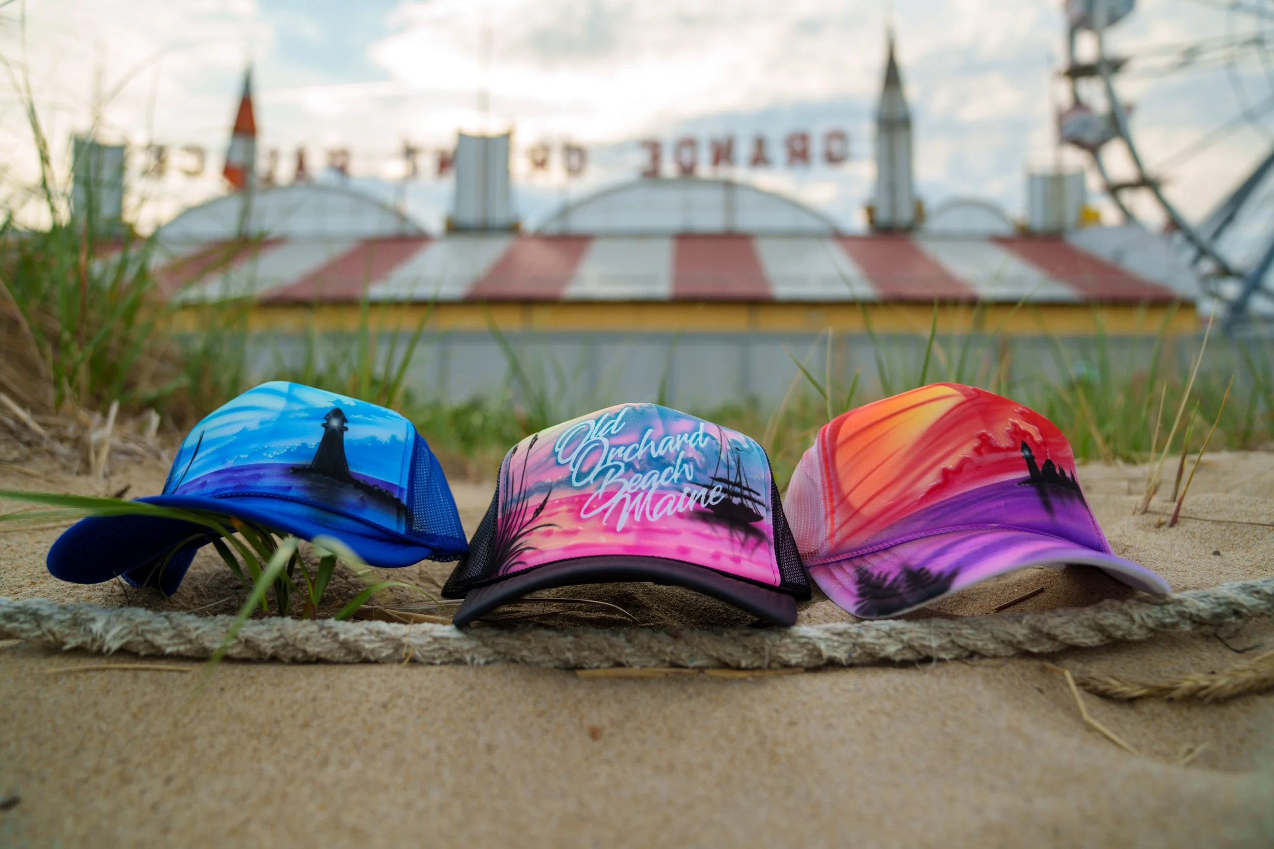 OOB Airbrush product shots of custom airbrush designed hats of various beach and Old Orchard Beach scenery