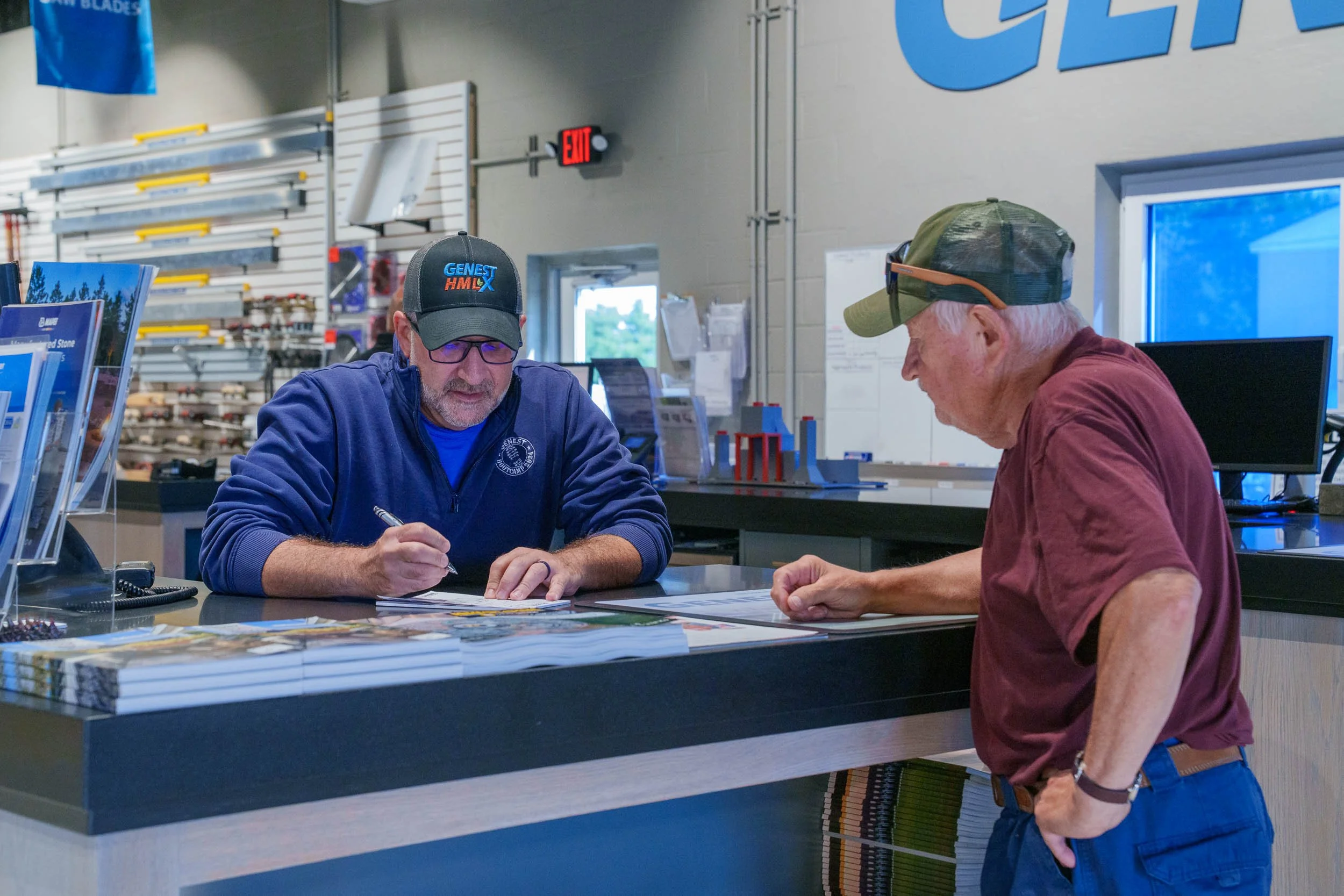 Genest Concrete Biddeford, Maine showroom staff assisting walk-in home-owner with an order during a commercial photo shoot.