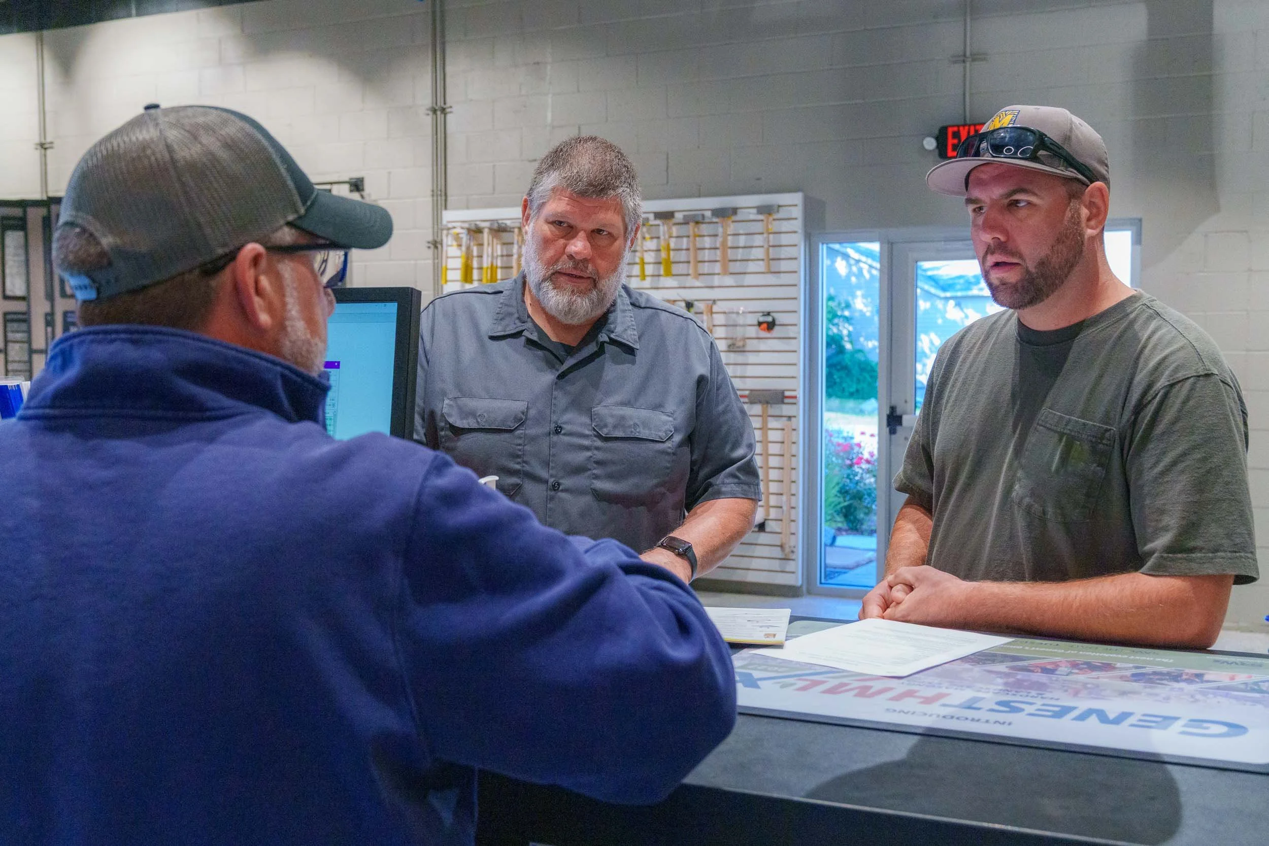 Genest Concrete Biddeford, Maine showroom staff assisting a contractor with placing an order during a commercial photo shoot.
