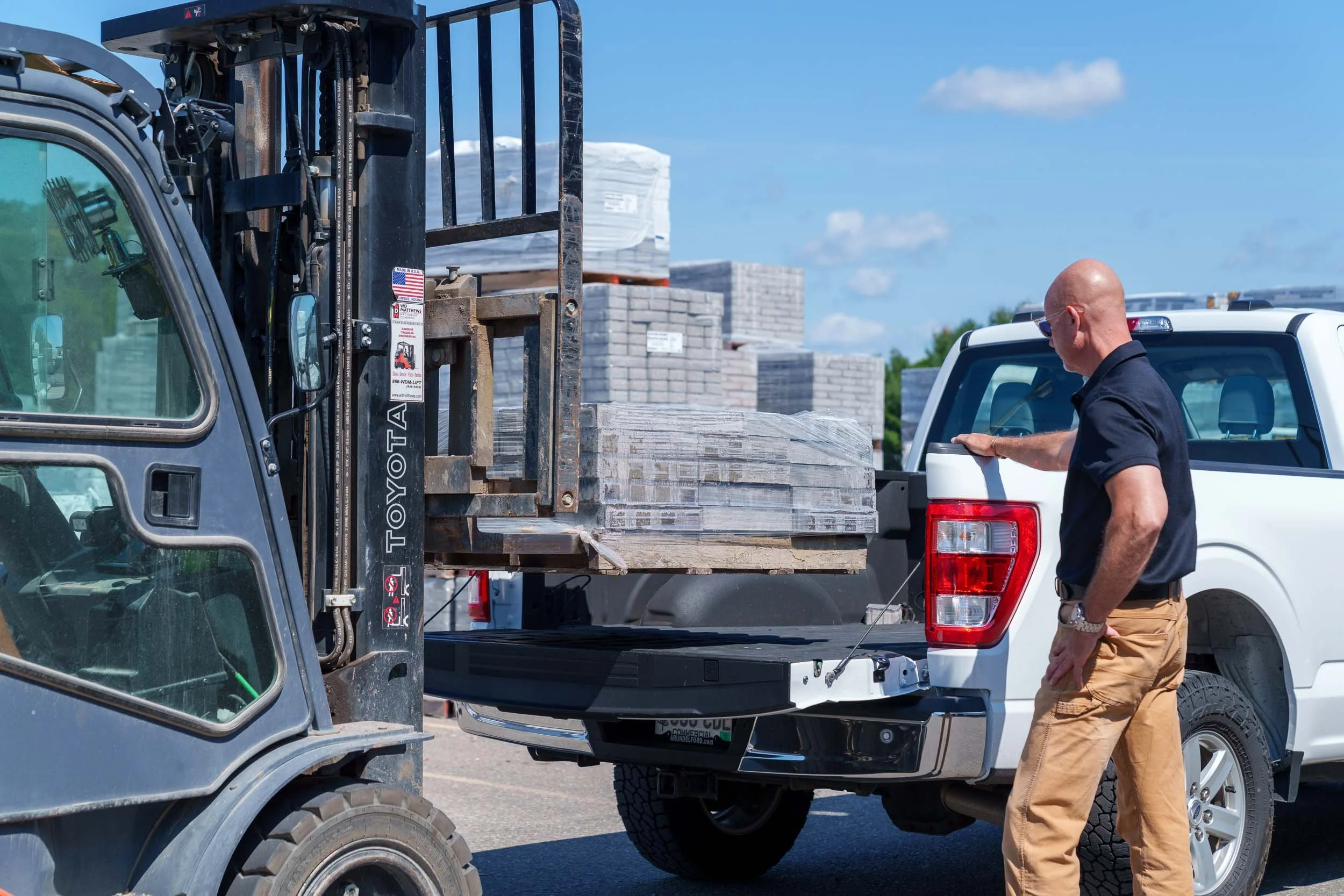 Men loading a truck with contractor supplies during a commercial photography shoot for Genest Concrete in Biddeford, Maine.