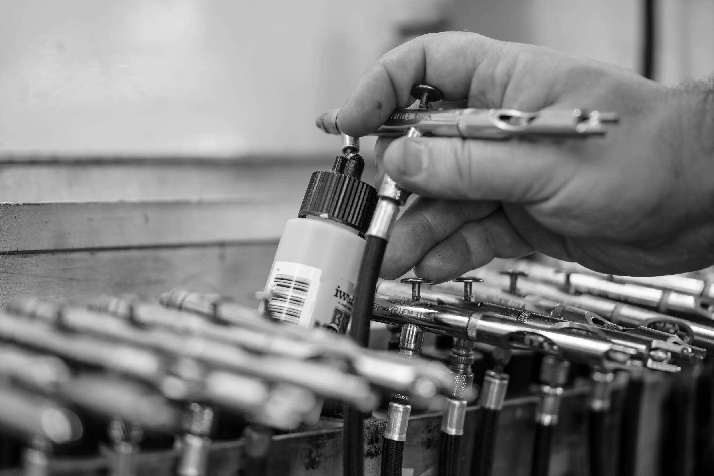 A close detail photograph of an apparel airbrush painter