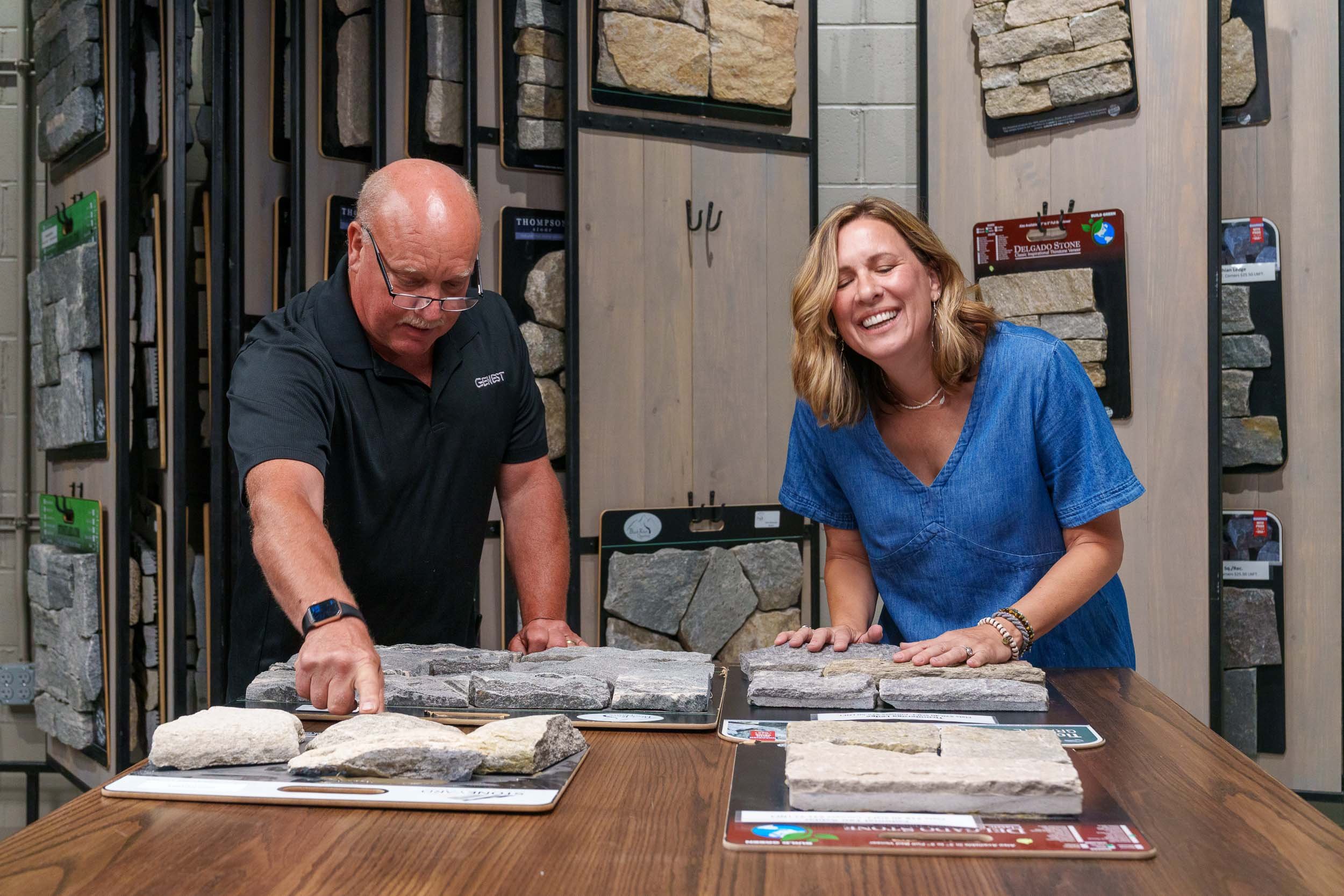 Interior designer reviewing samples with Genest Concrete Biddeford, Maine showroom staff.