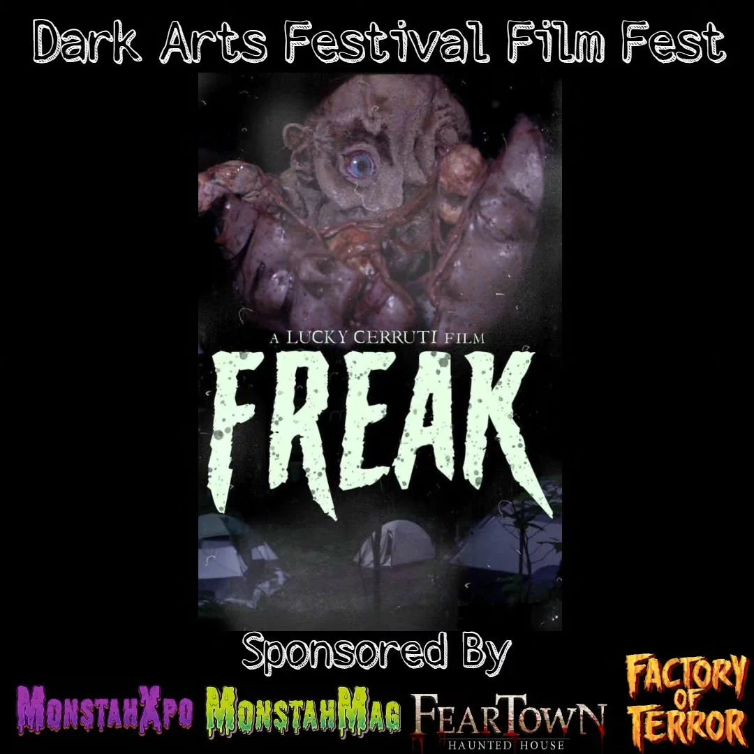 Poster for the Dark Arts Festival Film Fest featuring a horror movie called 'Freak' by Lucky Cerruti, with a creepy image of a doll with a disturbing face and tentacles, surrounded by tents at night, and logos for MonstahXpo, MonstahMag, FearTown Haunted House, and Factory of Terror.