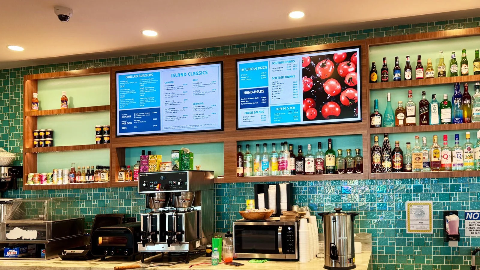 The Reef Restaurant in the gate area at Henry E Rohlsen (STX) Airport with menu and bar area.