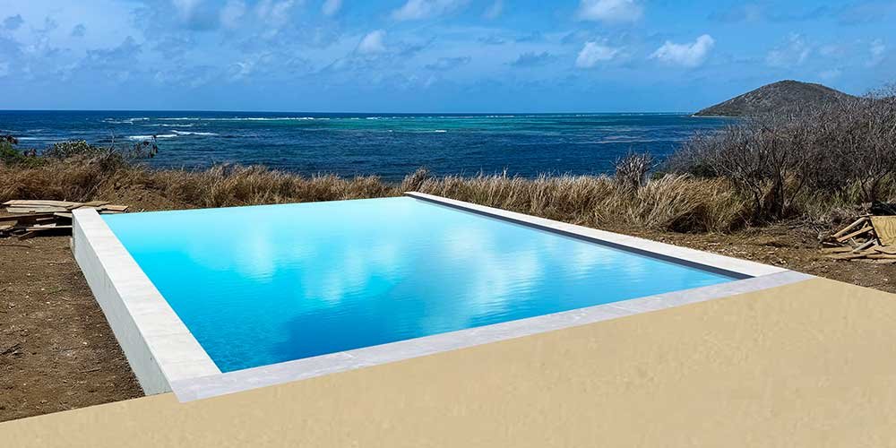 AI rendering of the infinity-edge pool at Turtle Bluff. The pool is under construction but the background is real. A rectangular swimming pool with bright blue water on the Caribbean Sea