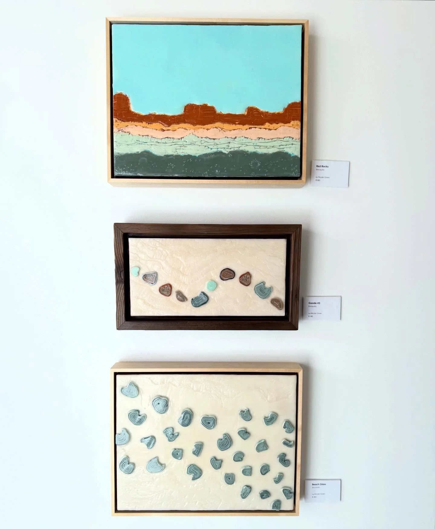 Some favorite moments from the current &ldquo;All Together Now&rdquo; show:
These three encaustic pieces by Nicole Given. All three pieces are inspired by different subjects, yet all three have a cohesive color story and consistency. Nicole&rsquo;s &
