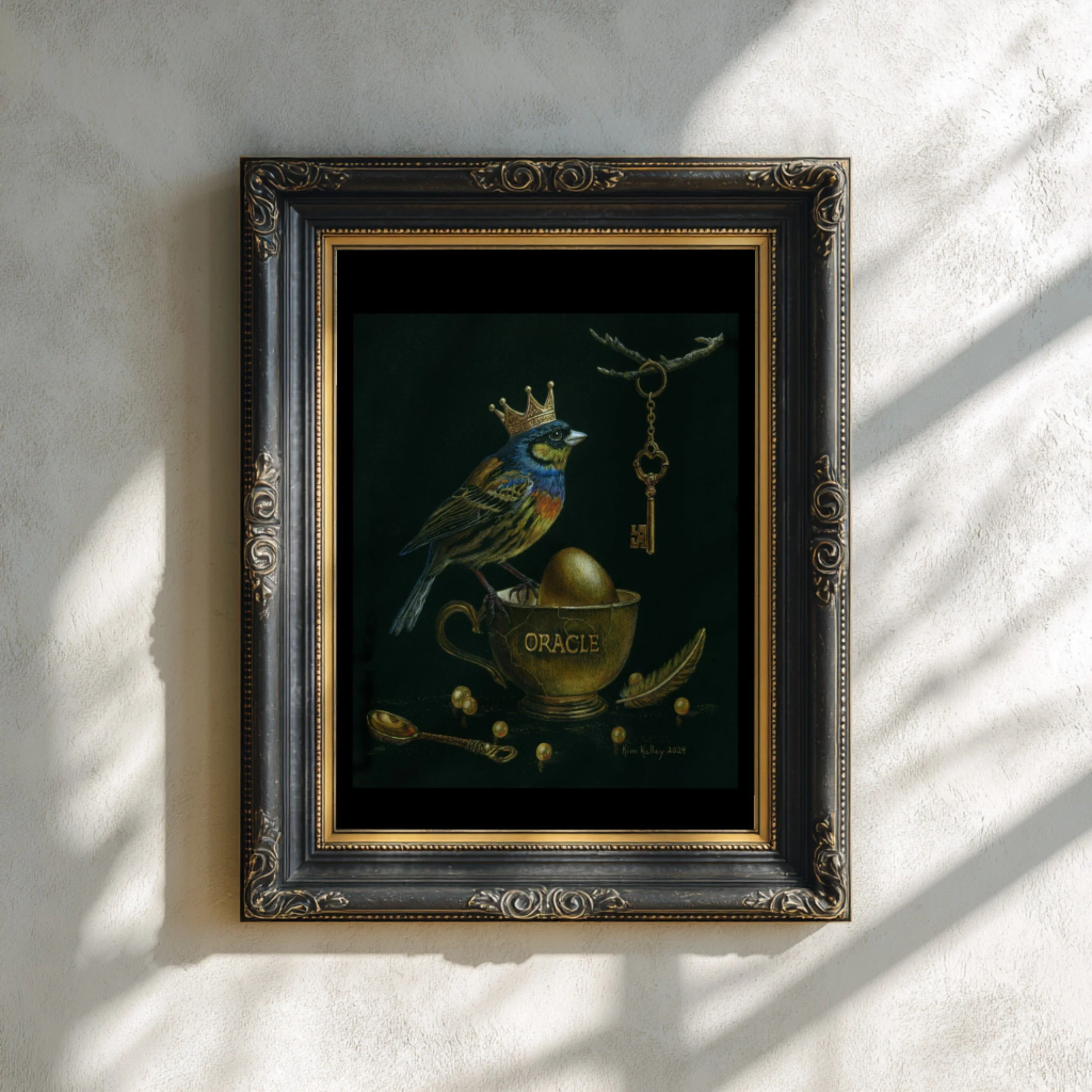 Mockup of ‘Key to Inner Riches’ fine art print from the Oracle of Feathers series, shown in a simple frame for presentation.