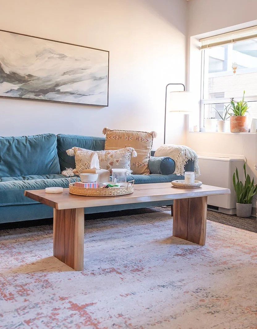 Calming therapist office with serene blue sofa and plants