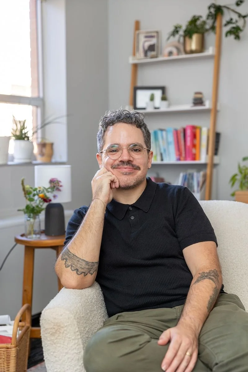 Braden (therapist) sitting in light-filled office with warm smile.