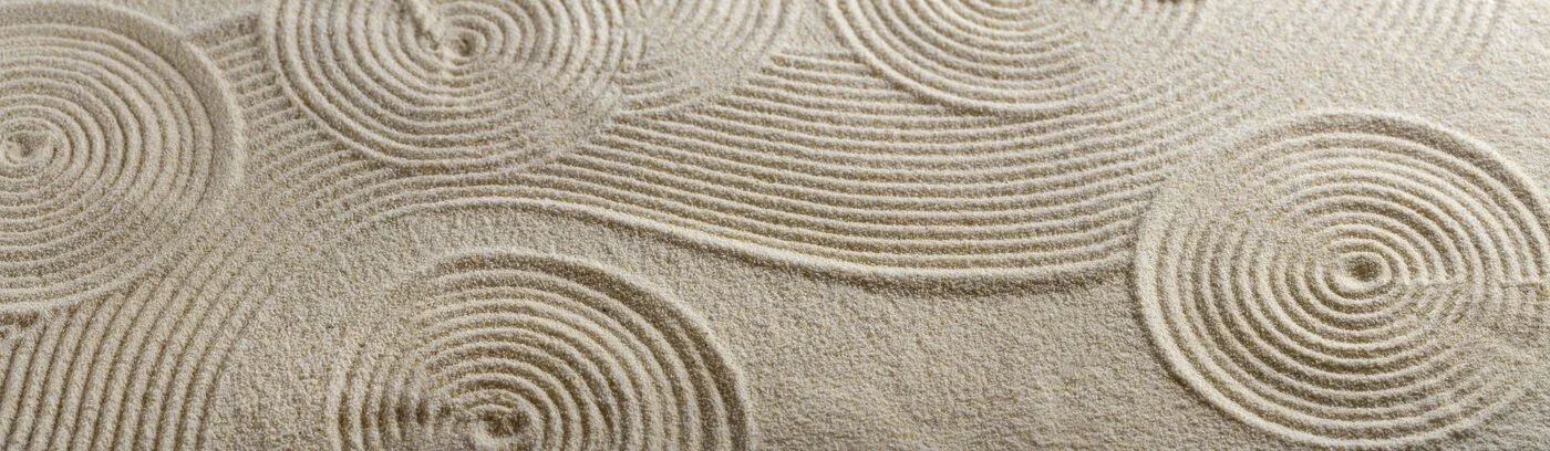 Close-up of sand with circular Zen garden patterns