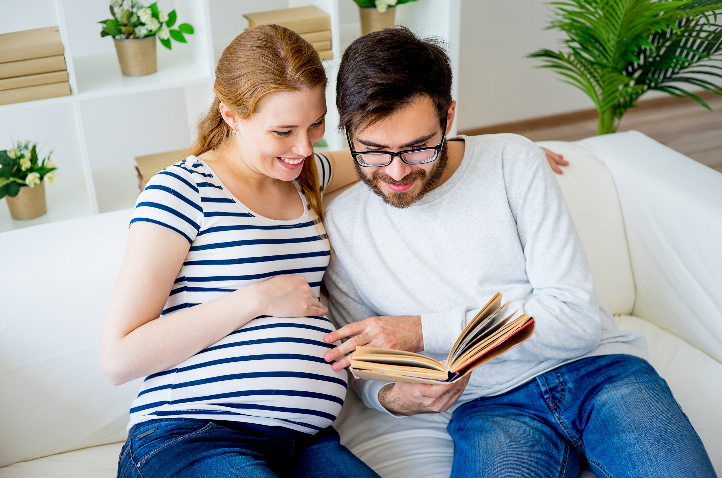 Pregnant couple preparing for birth together at home – antenatal classes East Devon