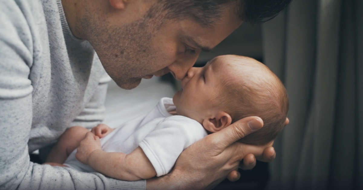 dad-looking-lovingly-into-newborn-babies-eyes.png