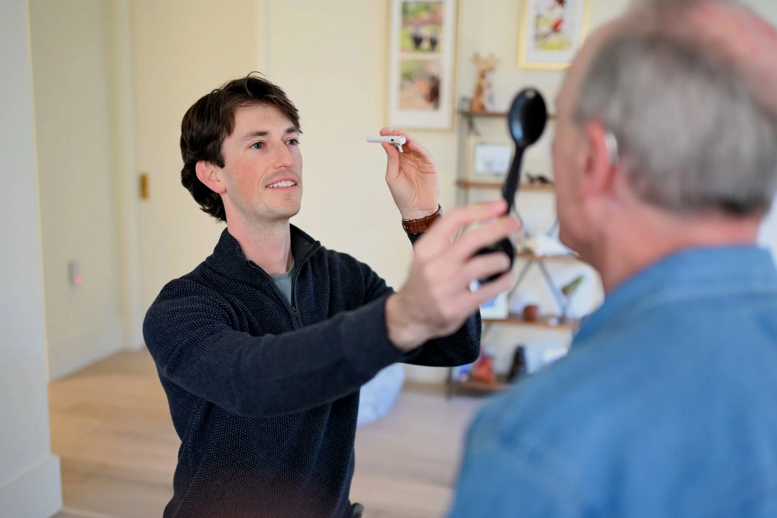 Justin Martin, PT, DPT, of StillPoint Balance and Dizziness performing testing during an in-home physical therapy evaluation in Austin, Texas
