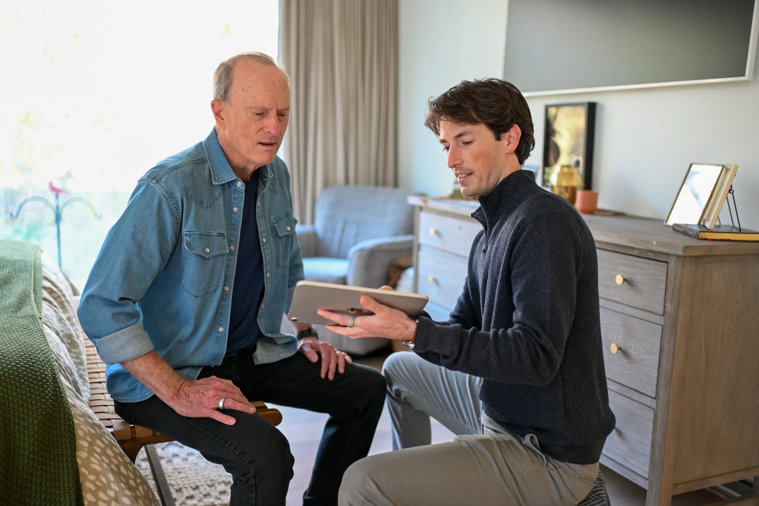 Justin Martin, PT, DPT, of StillPoint Balance and Dizziness providing patient education in an in-home physical therapy evaluation in Austin, Texas