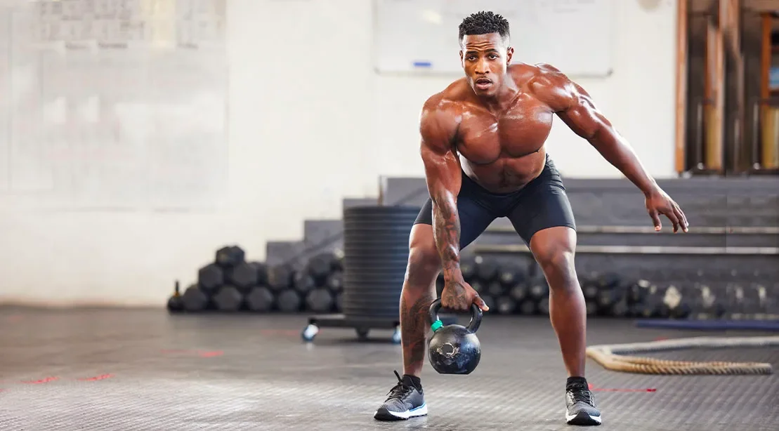 Fit-tall-black-man-performing-a-4-week-kettlebell-transformation-workout-for-his-strength-and-conditioning-goals.webp