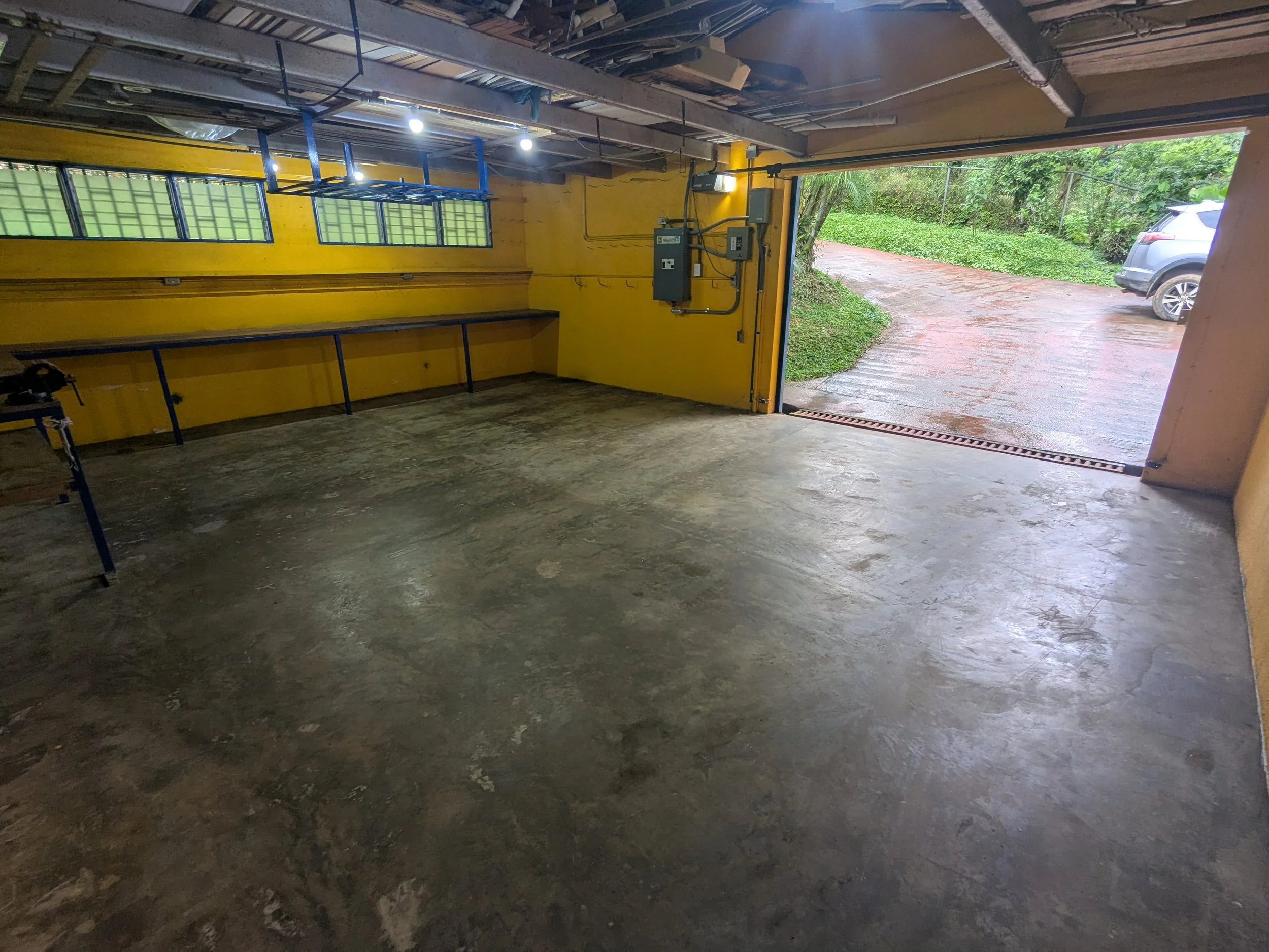 Spacious 2 car garage with workbench.