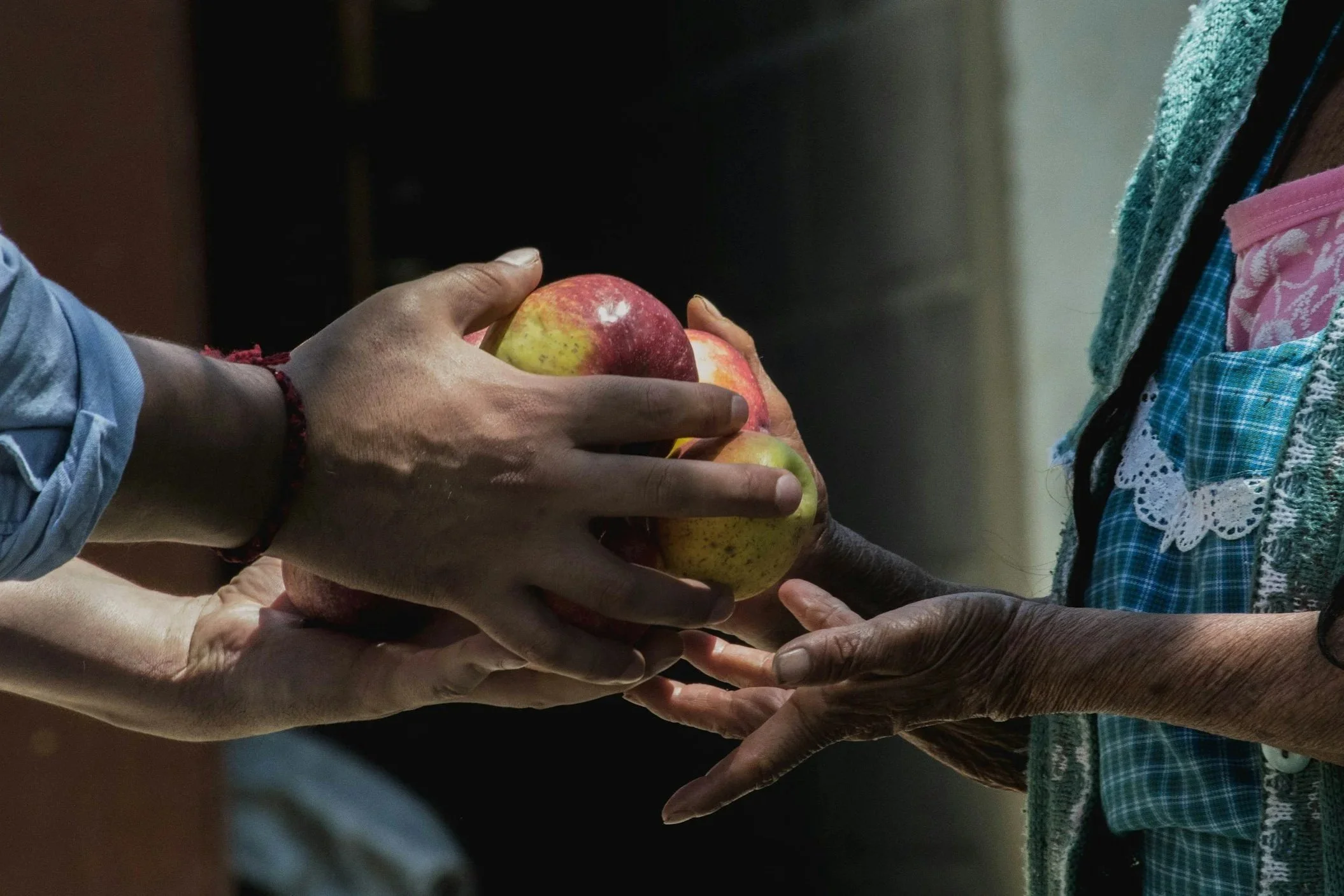 Someone offering an apple to someone in need.