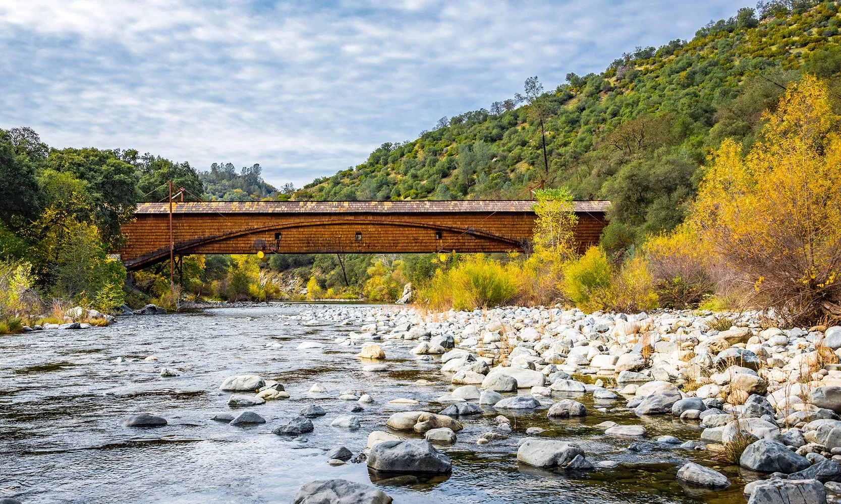 Scenic covered bridge and river landscape in Nevada County, showcasing the natural beauty of the Grass Valley area.