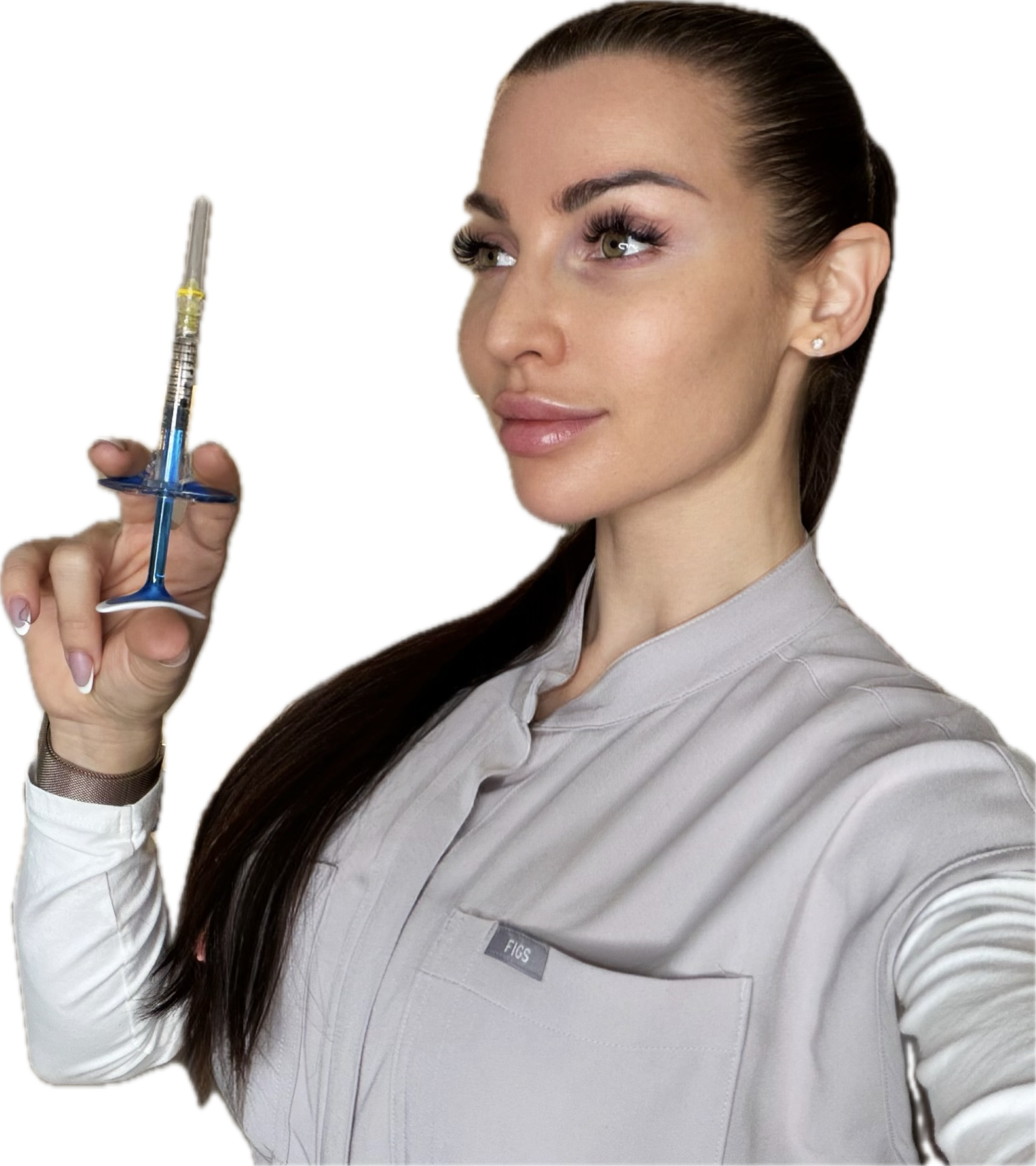 A woman with long dark hair holding a syringe in her right hand, her finger pointing upward, wearing a medical scrub top, with a confident expression.