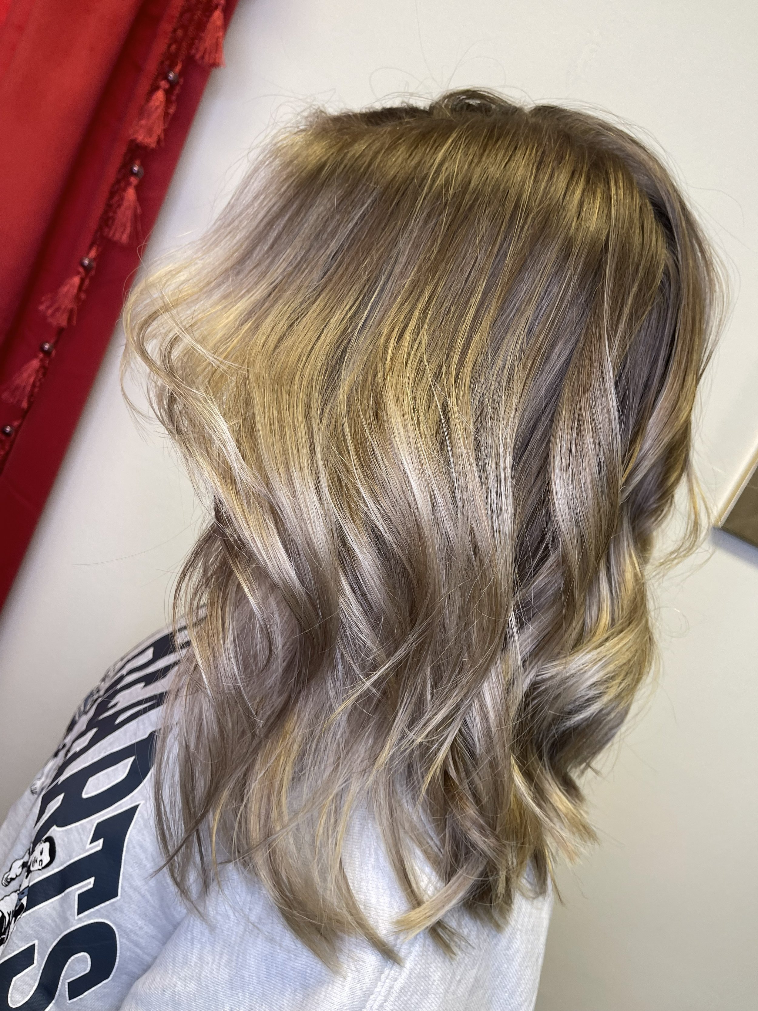 Woman with shoulder-length, wavy blonde hair.