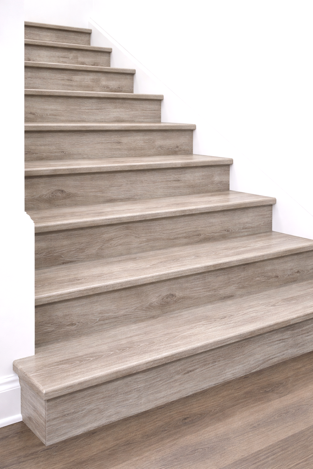 Wooden staircase with light-colored steps and white wall on the side.