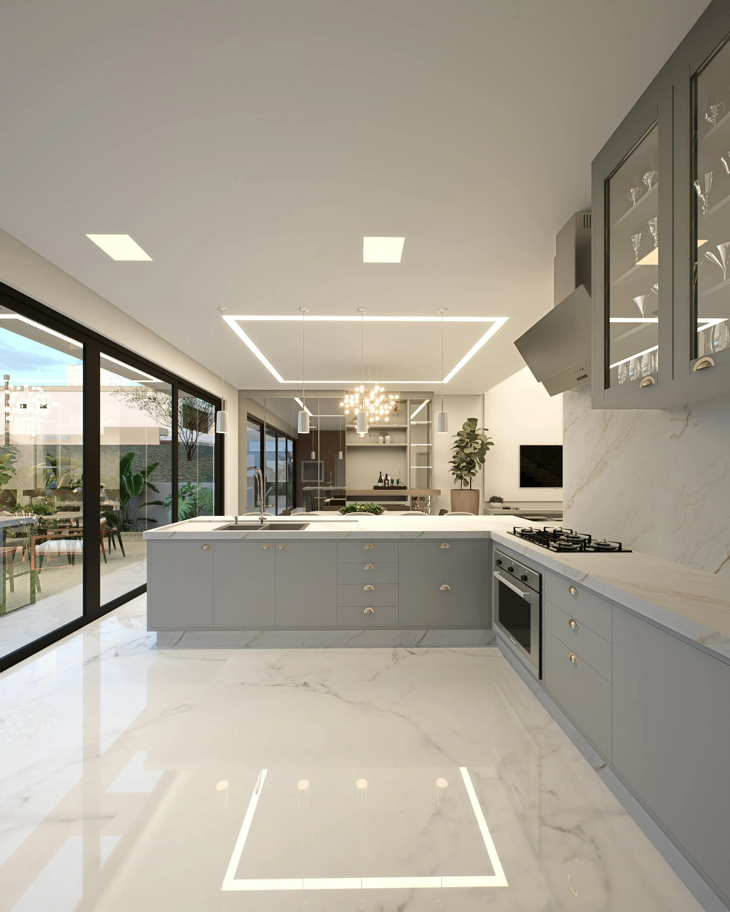 Modern kitchen with gray cabinets, marble countertops, and built-in appliances, opening to an outdoor patio with chairs and a dining table, under a white ceiling with recessed lighting.