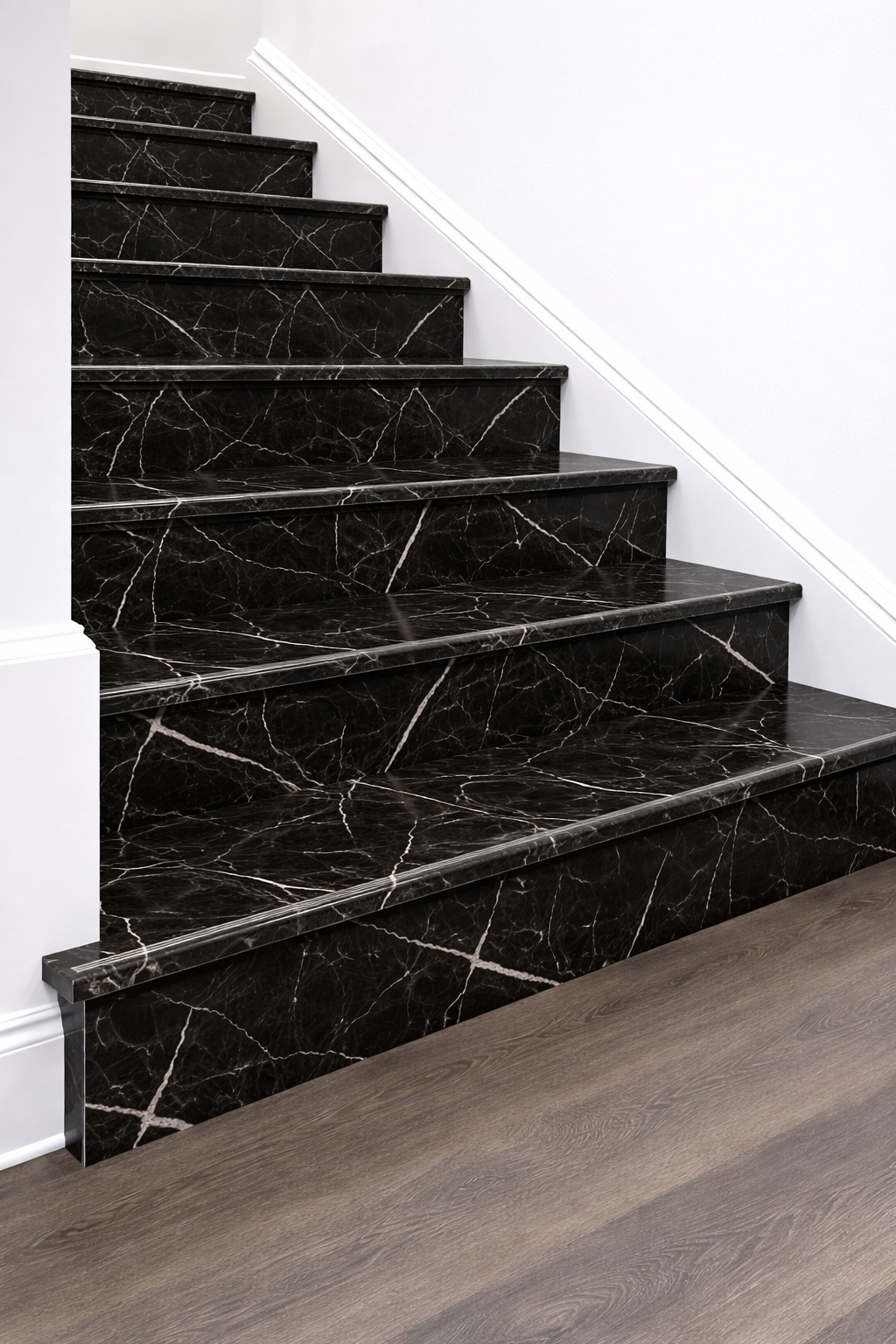 Black marble staircase with white veining and white baseboards in a modern interior.