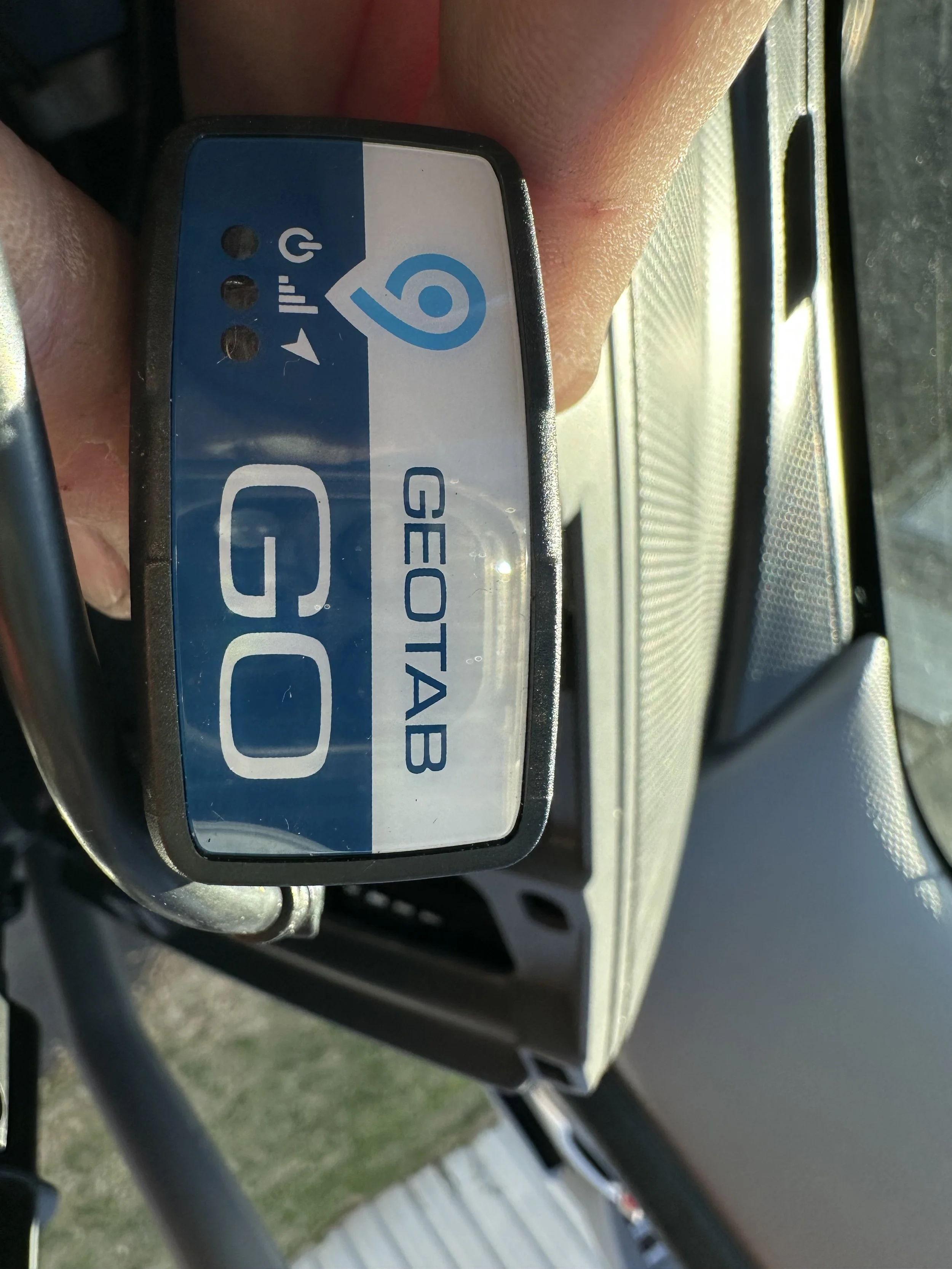 Installed Geotab GO telematics device mounted inside vehicle for GPS tracking and fleet monitoring.