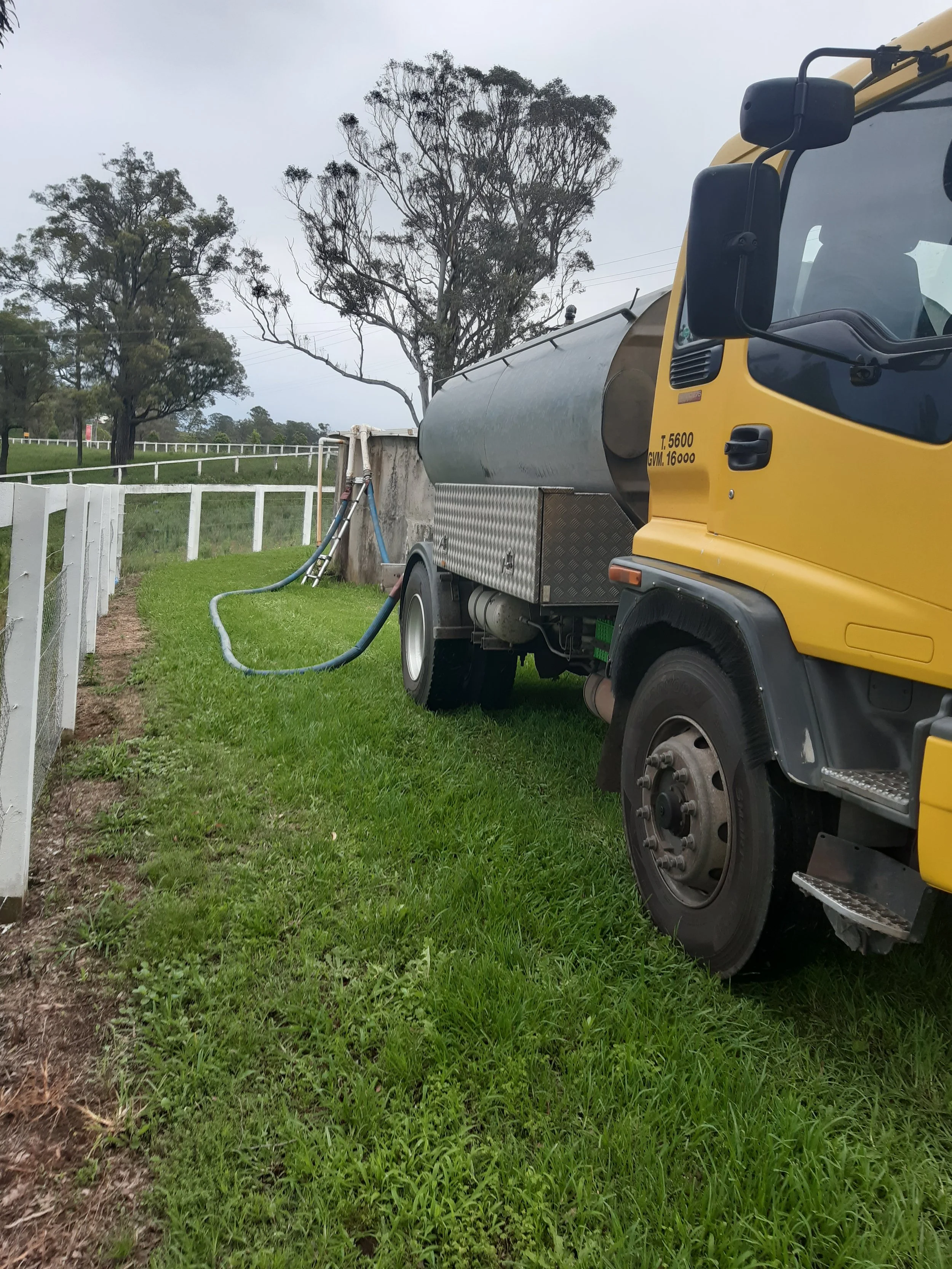 Water truck filling a customers water tank