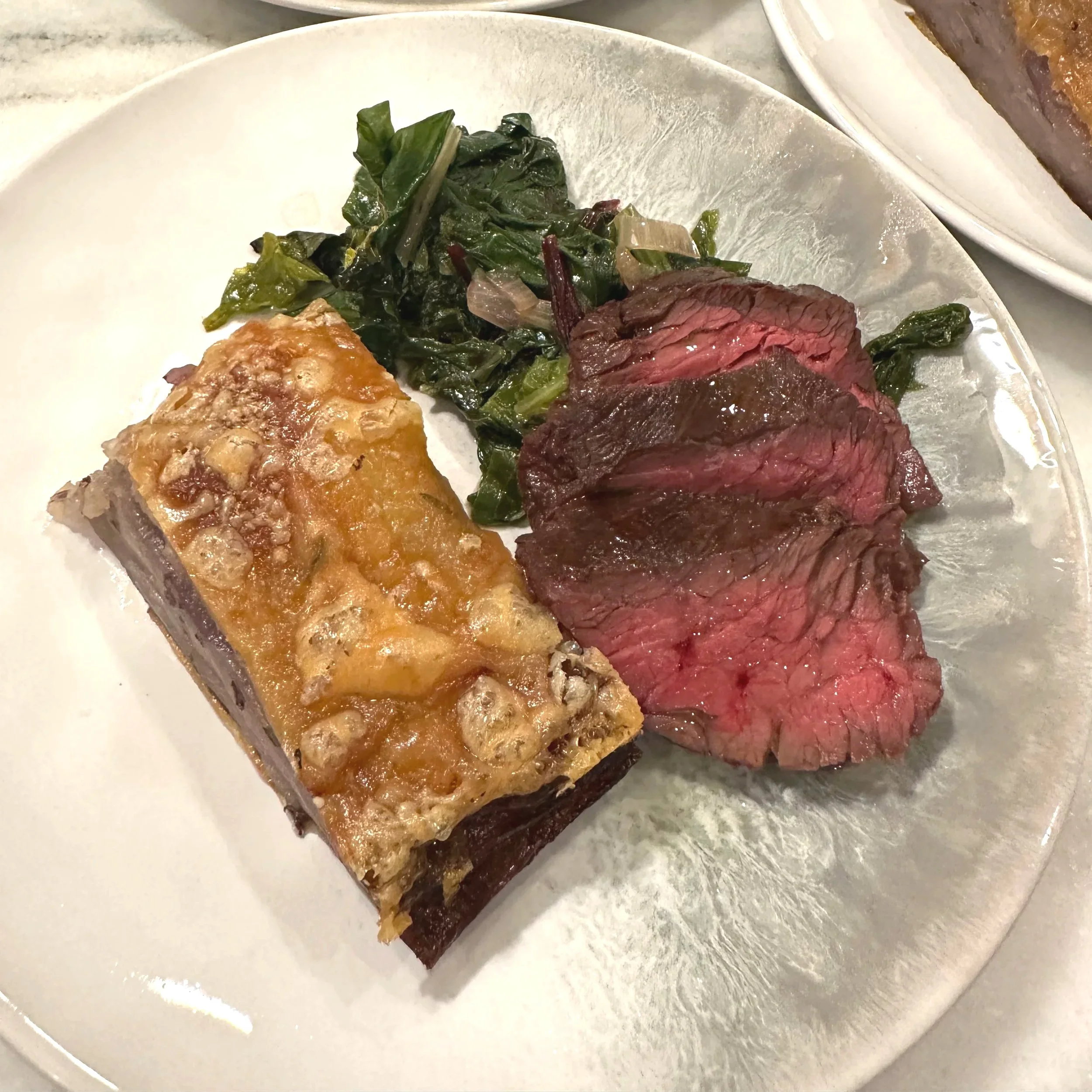 Hanger steak, winter greens, and mille-feuille style purple potatoes.