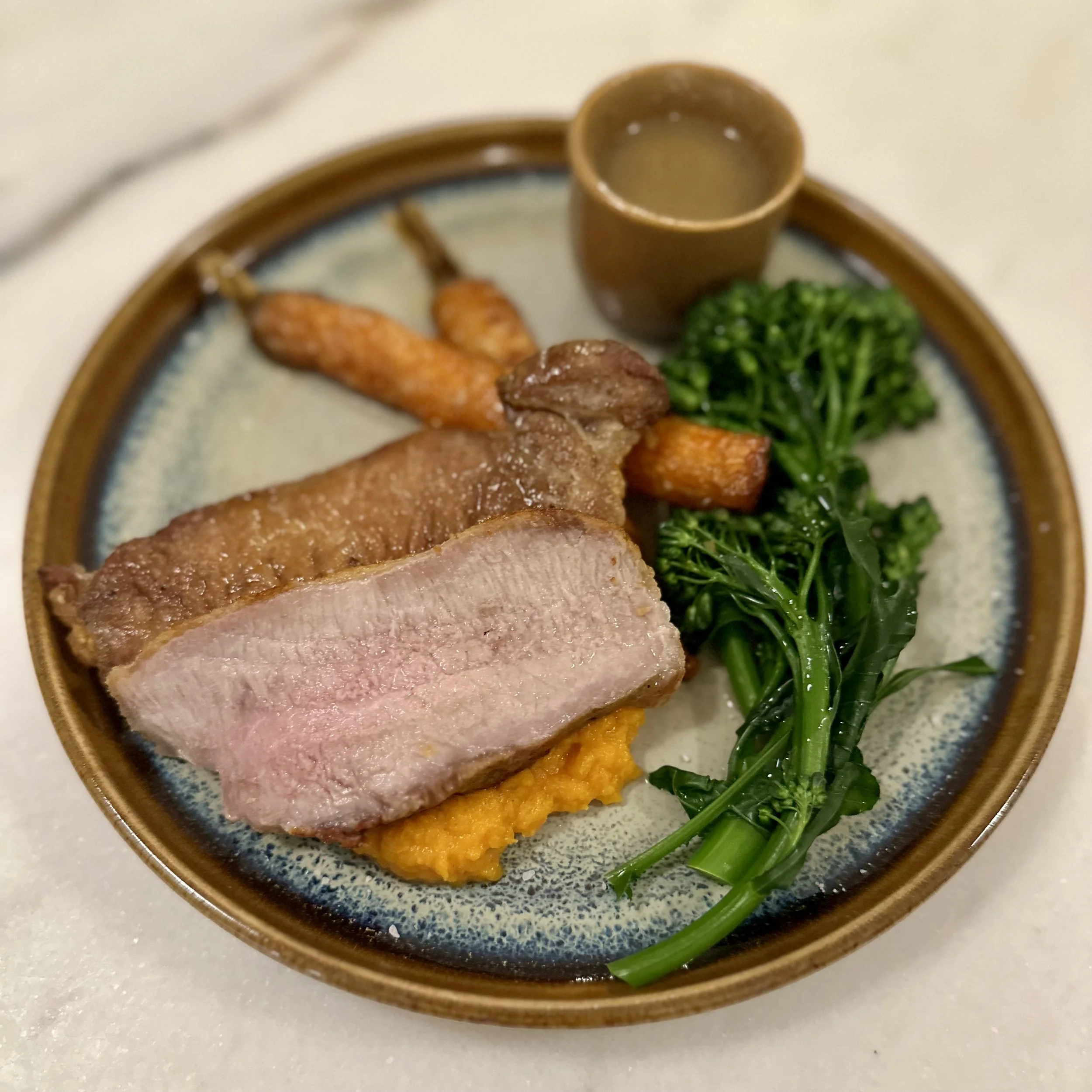 Iberico Pork loin with carrots, broccolini, and pan sauce.