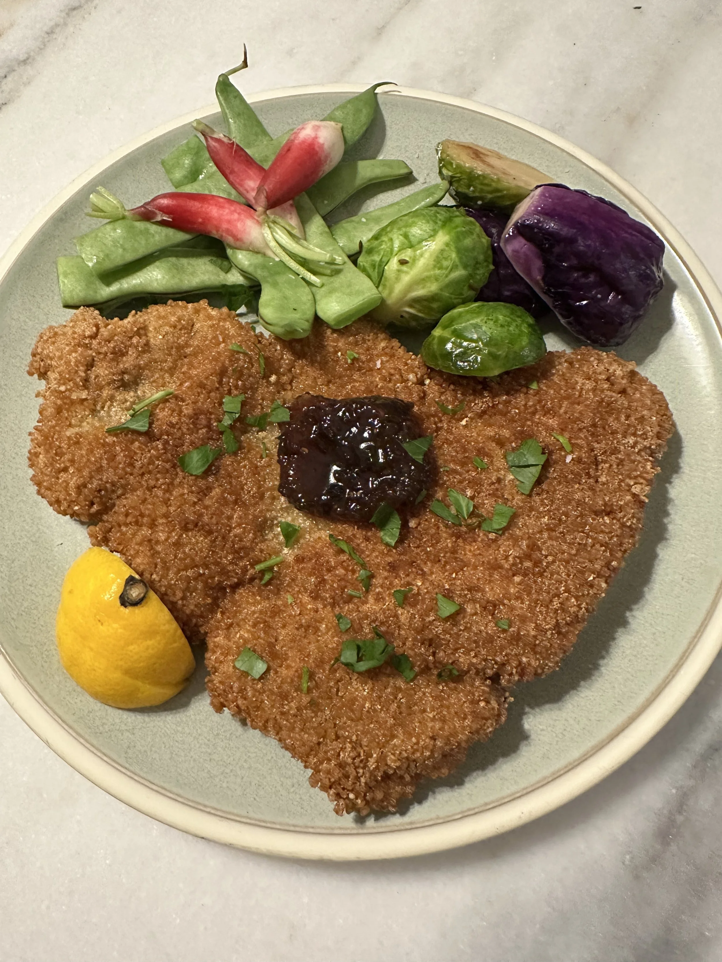 Schnitzel with Italian beans, radish, brussels, and baby purple cabbage. Served with raspberry jalapeño preserves.