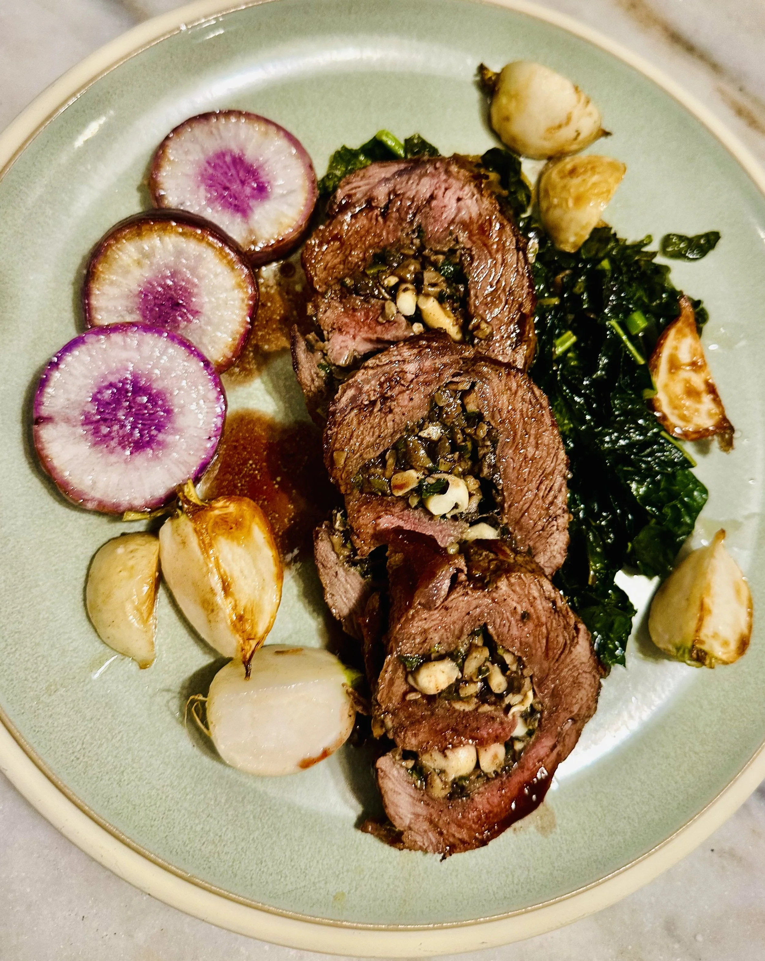 Mushroom stuffed flat iron steak, winter greens, radishes, and turnips. Sauced with a red wine pan sauce. 