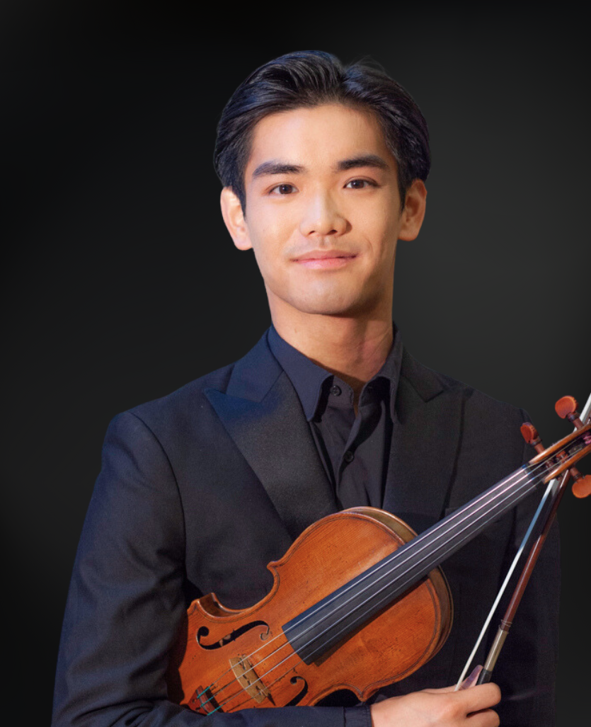Young man in black suit holding a violin and bow against a dark background.