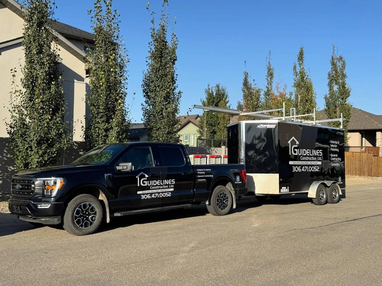 A black pickup truck and trailer with