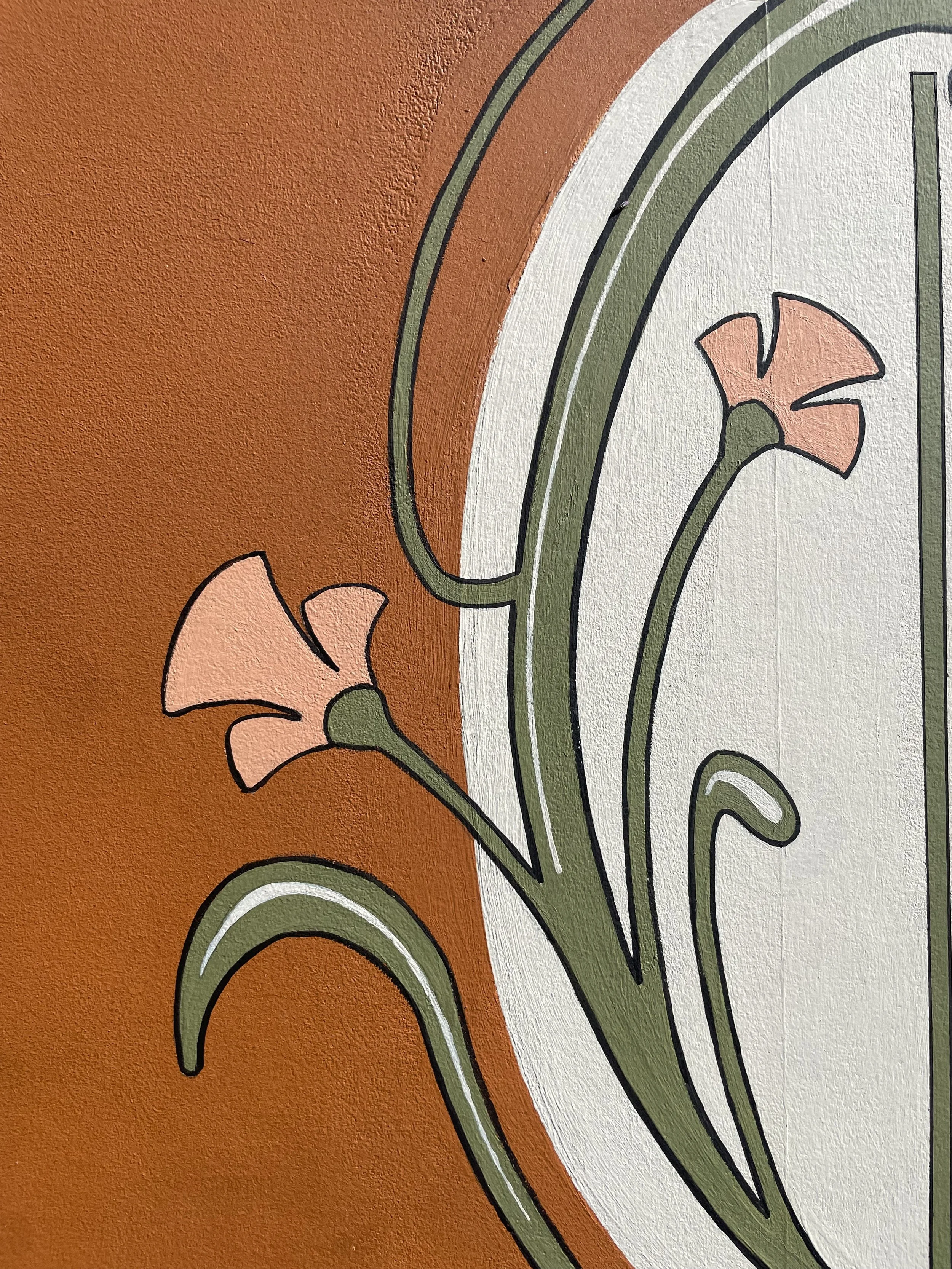 Up close sign detail: painted floral work