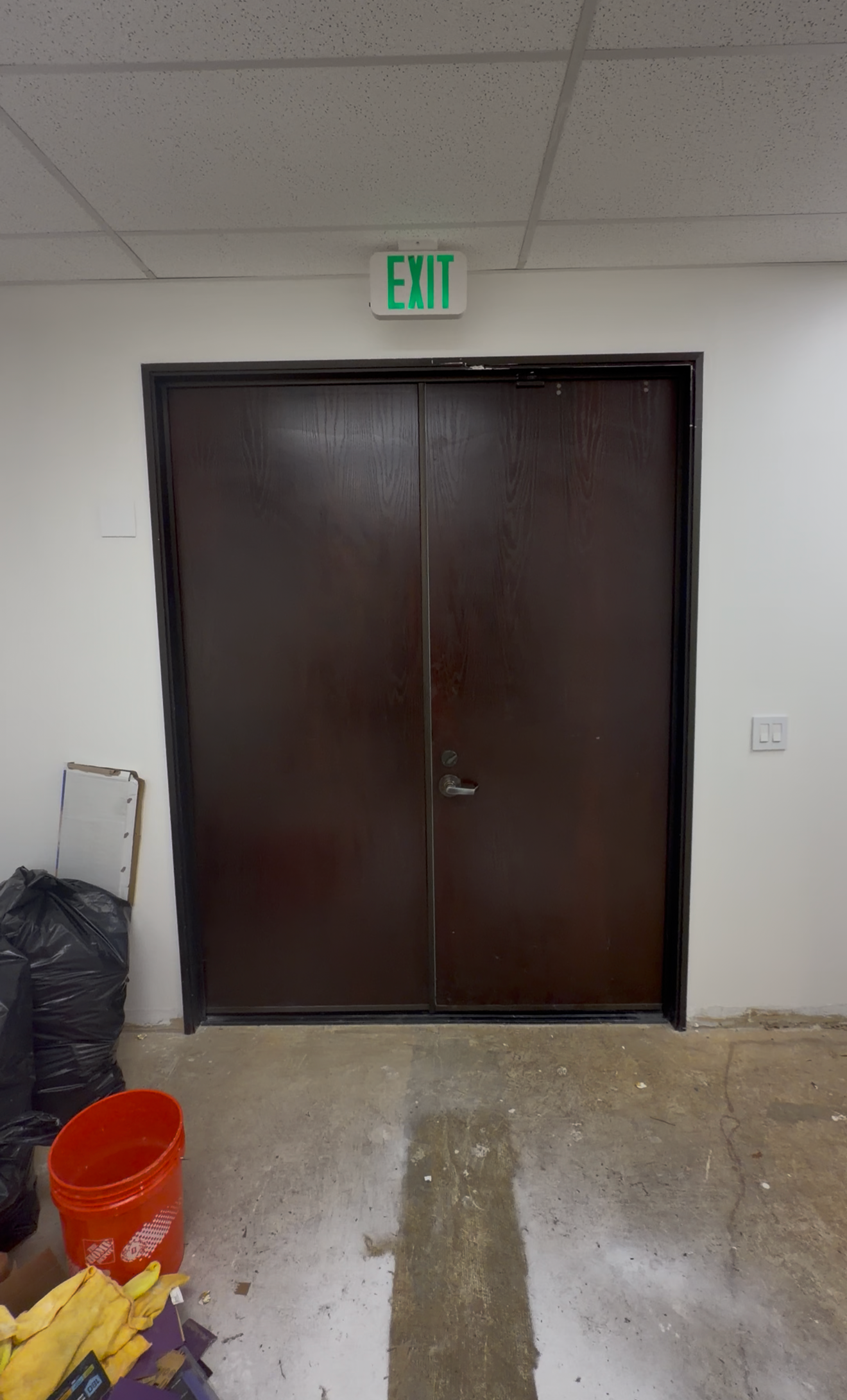Main entrance doors before MejjaPro renovation — worn and dated