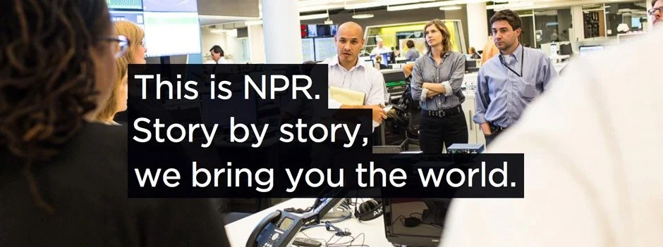 A diverse group of news reporters and producers in a newsroom, with some looking at a woman speaking, and a text overlay that reads "This is NPR. Story by story, we bring you the world."