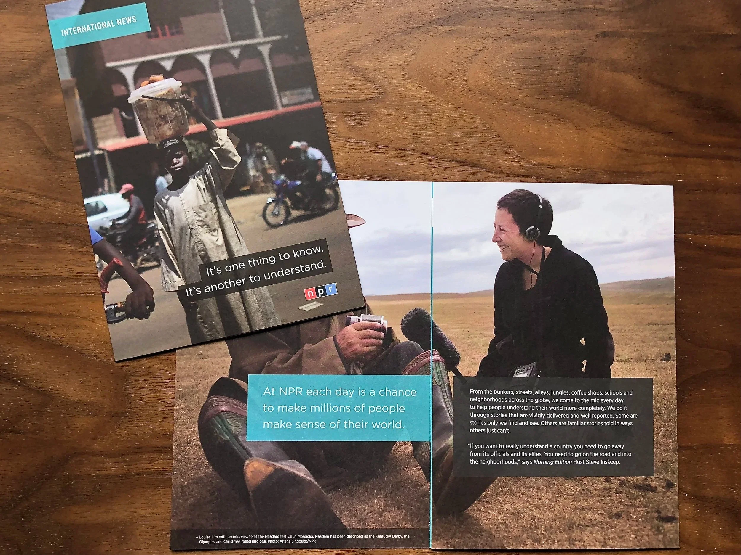 Two pages of a magazine or brochure featuring two photographs. The left page shows a woman in traditional African attire walking along a street, carrying a container on her head, with a quote saying "It's one thing to know. It's another to understand," and the NPR logo. The right page shows a woman laughing outdoors in a wide open field, wearing headphones, with text about NPR stories helping people understand the world.