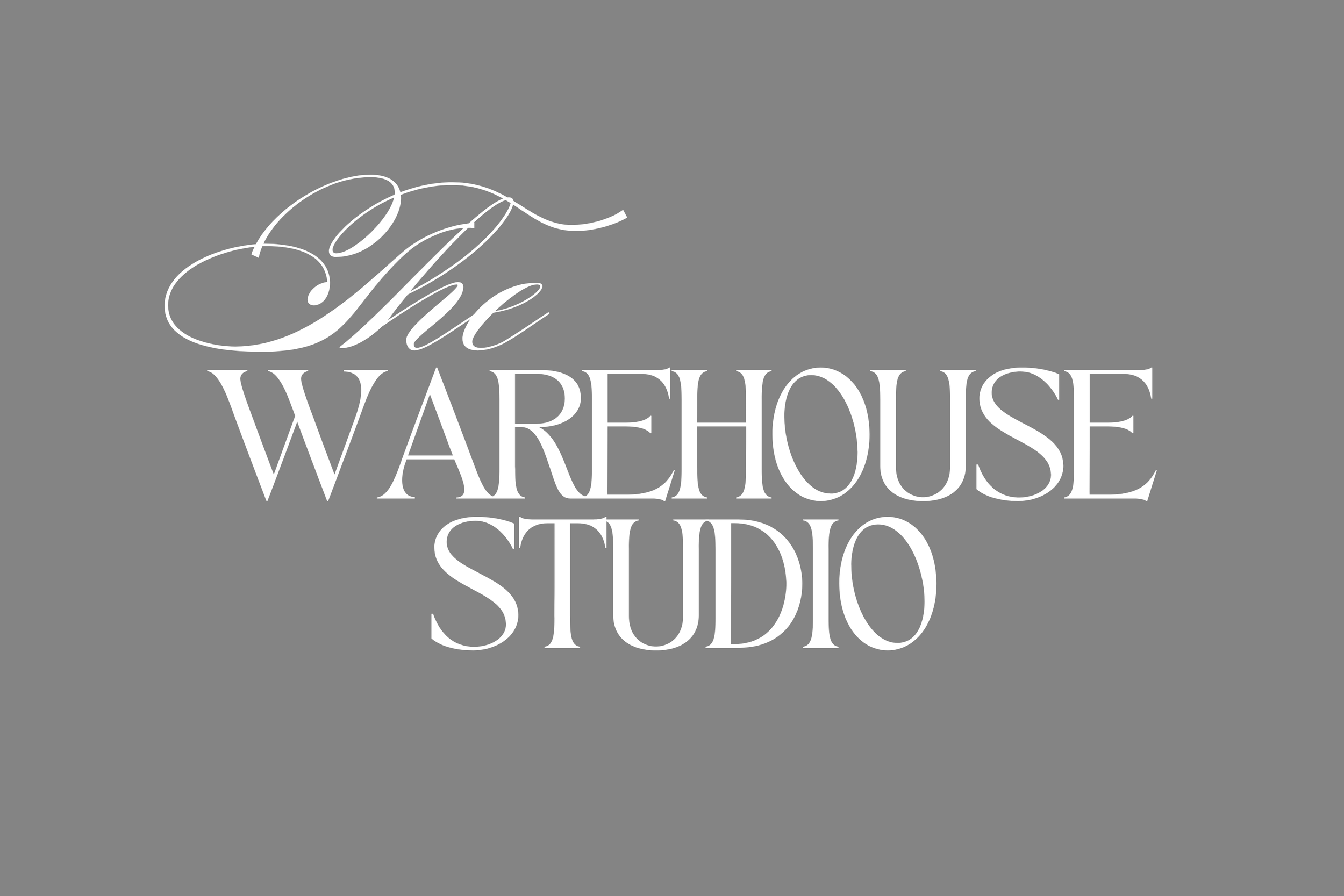 Gray background with white text that reads "The Warehouse Studio" in elegant script and bold font.