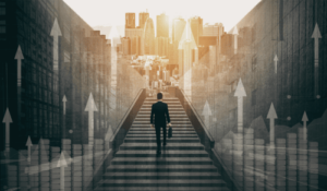 A person walking up a staircase in an urban city with tall buildings, with upward pointing arrows overlayed and sunlight overhead